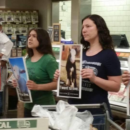 Arwen, along with co-organizer Maria-Adriana Rojas, protests inside of a Whole Foods