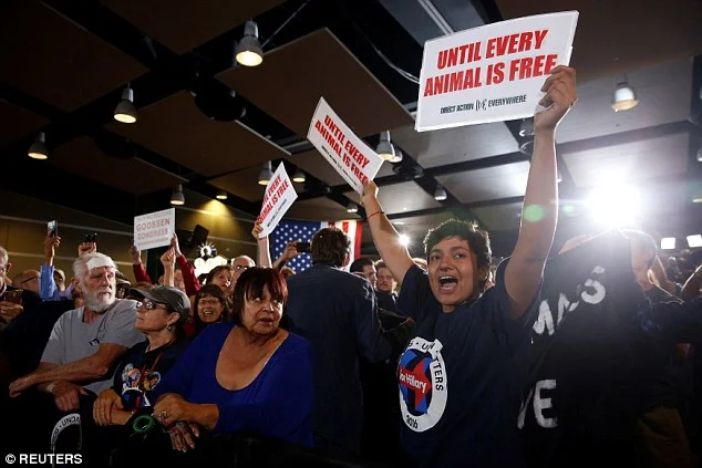 Hillary Clinton gets heckled by animal rights activists - and blames their appearance on Donald Trump and his sons who have 'killed lots of animals'