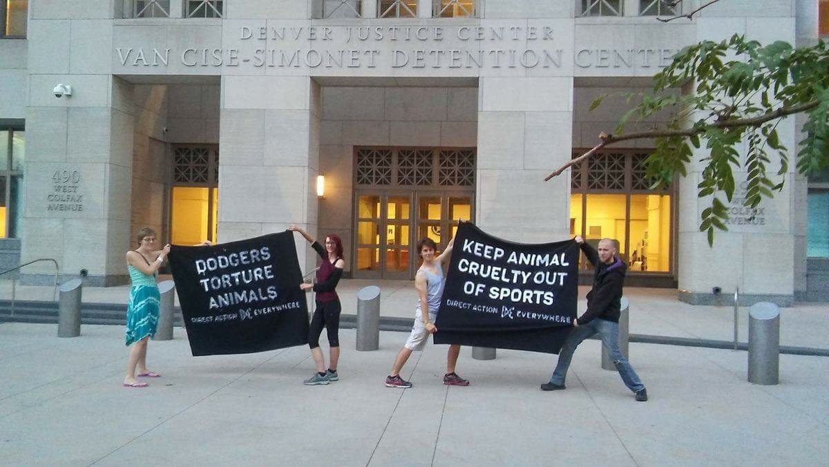 After being released from jail, Kaelyn, Alyssa, Charles, and Aidan show off their homemade, cloth animal liberation banners