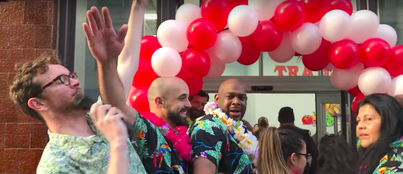 DxE disrupting Trader Joe's grand opening in San Francisco. Pictured: Zach Groff wearing Trader Joe's attire, talking about Trader Joe's history of abusing animals. 