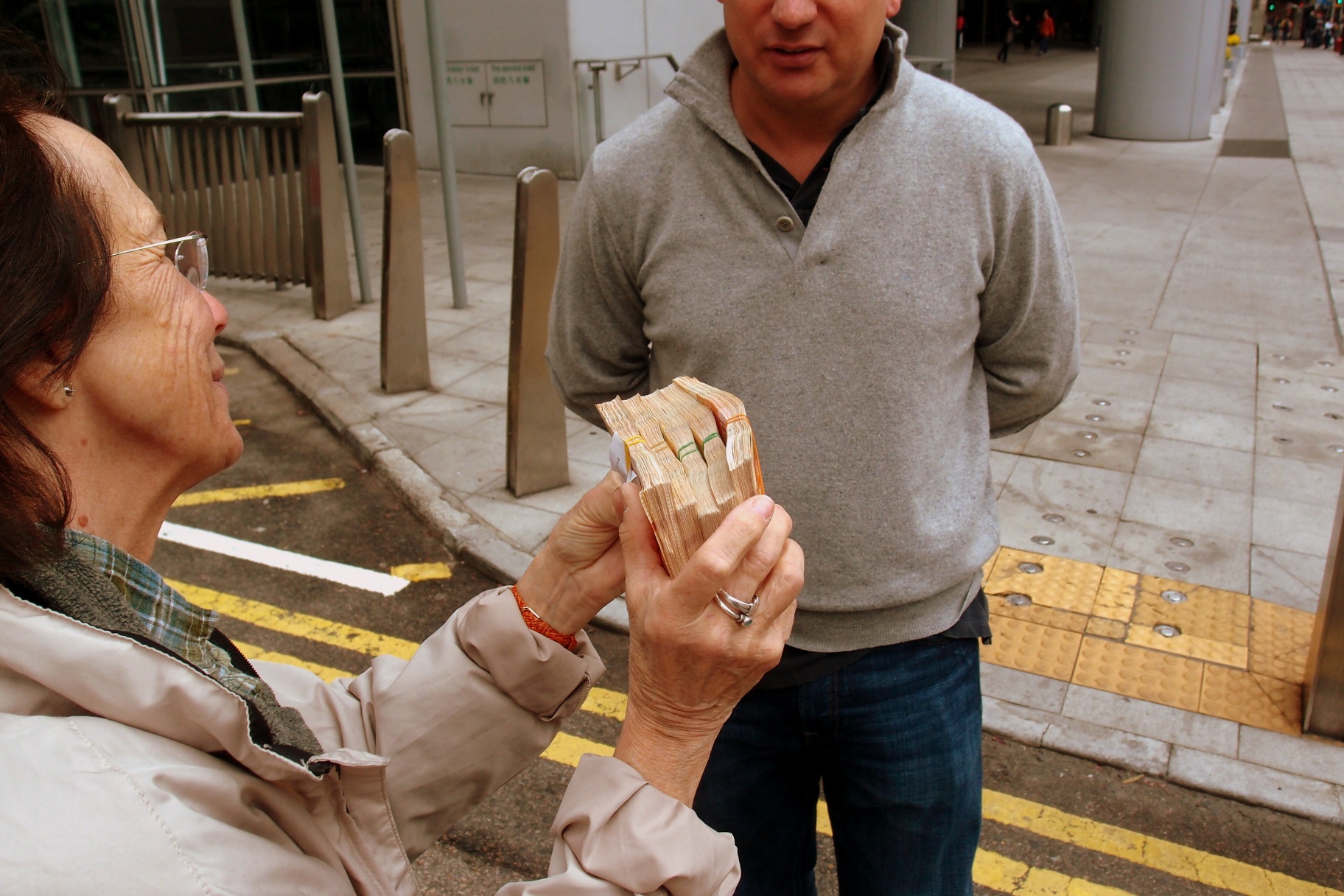 A slightly drunk expat jigs in the street with his winnings on the horses...