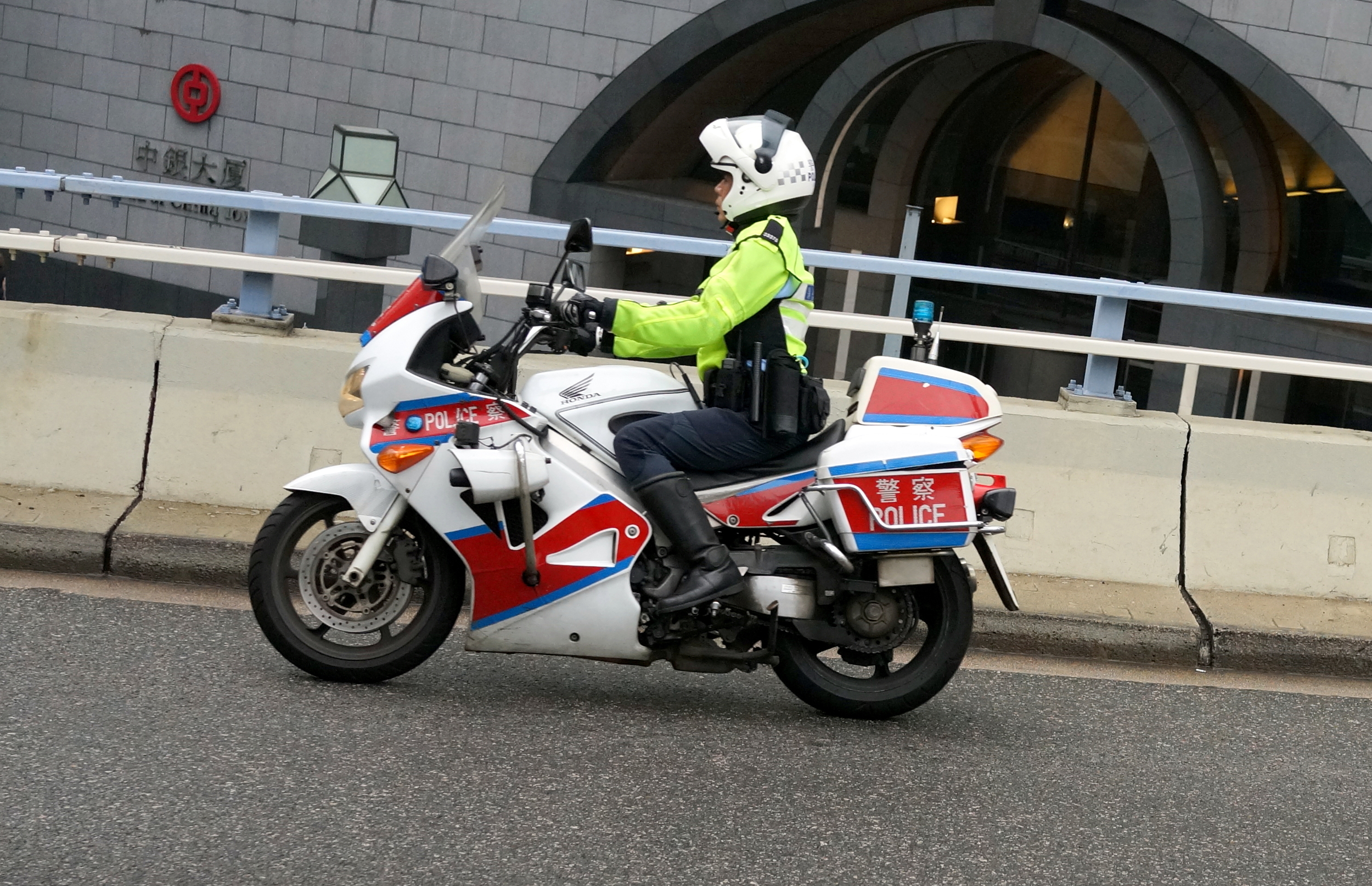 A traffic cop doing his thing on a murky day in Central District.
