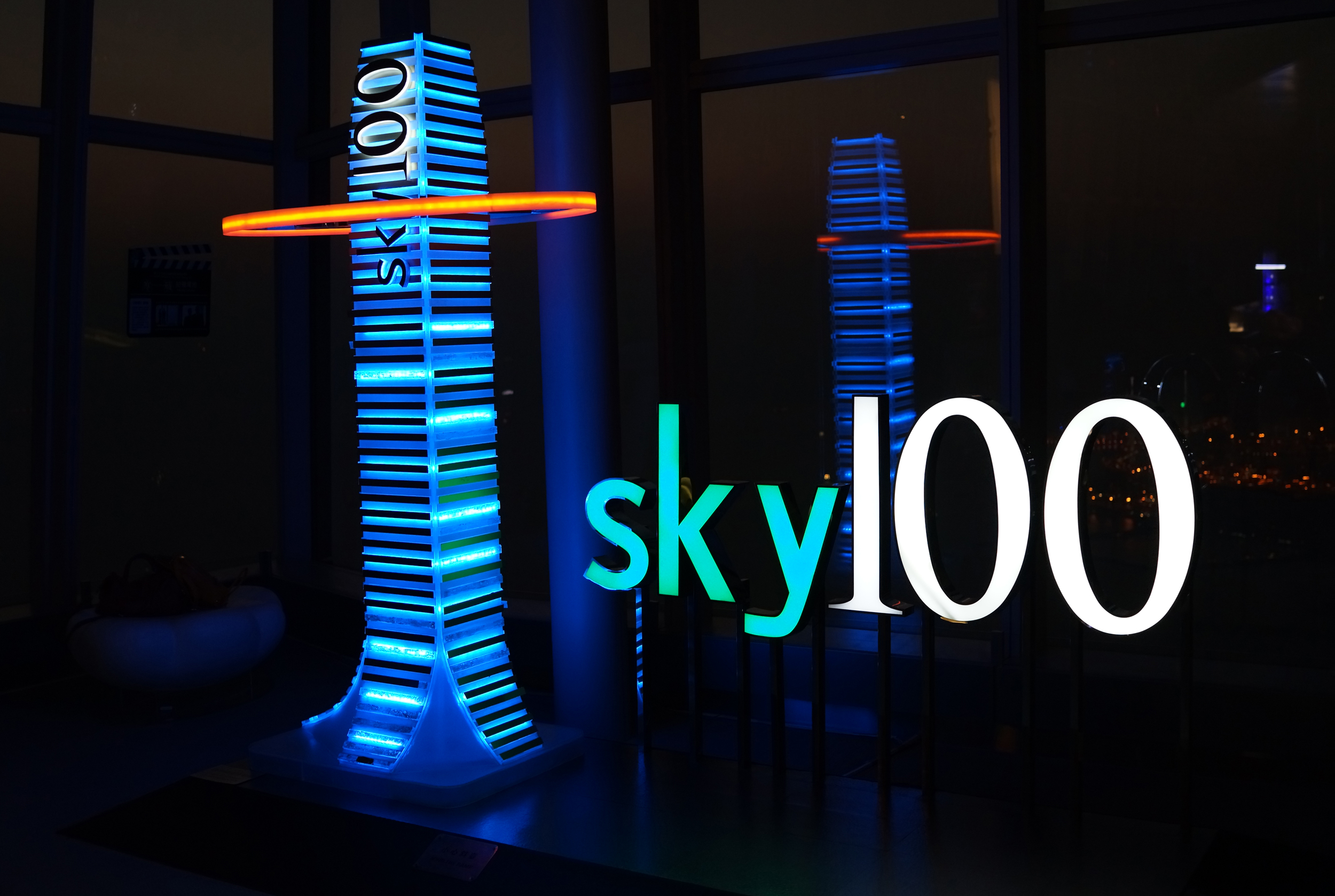 I finally got to visit Sky 100 on the 100th Floor of the ICC Building | I was there to cover the period from dusk to night. The "attraction" itself is the entire 100th floor and the layout etc is just great but sadly at night time there is to much reflection in the windows and the windows themselves are too thick so images are quite distorted which is a shame. I have been to the Ritz Carlton lobby many times on the 103rd floor so I have seen the daytime view and the problem is the same... imagine if they had a corner with no windows ( I imagine that to be technically feasible) then the views would be staggering. It is not cheap at HK$168 (US$21.50) for an adult and you do get 360 degree views but quite simply it is NOT a patch on the view from my spot at the Peak.