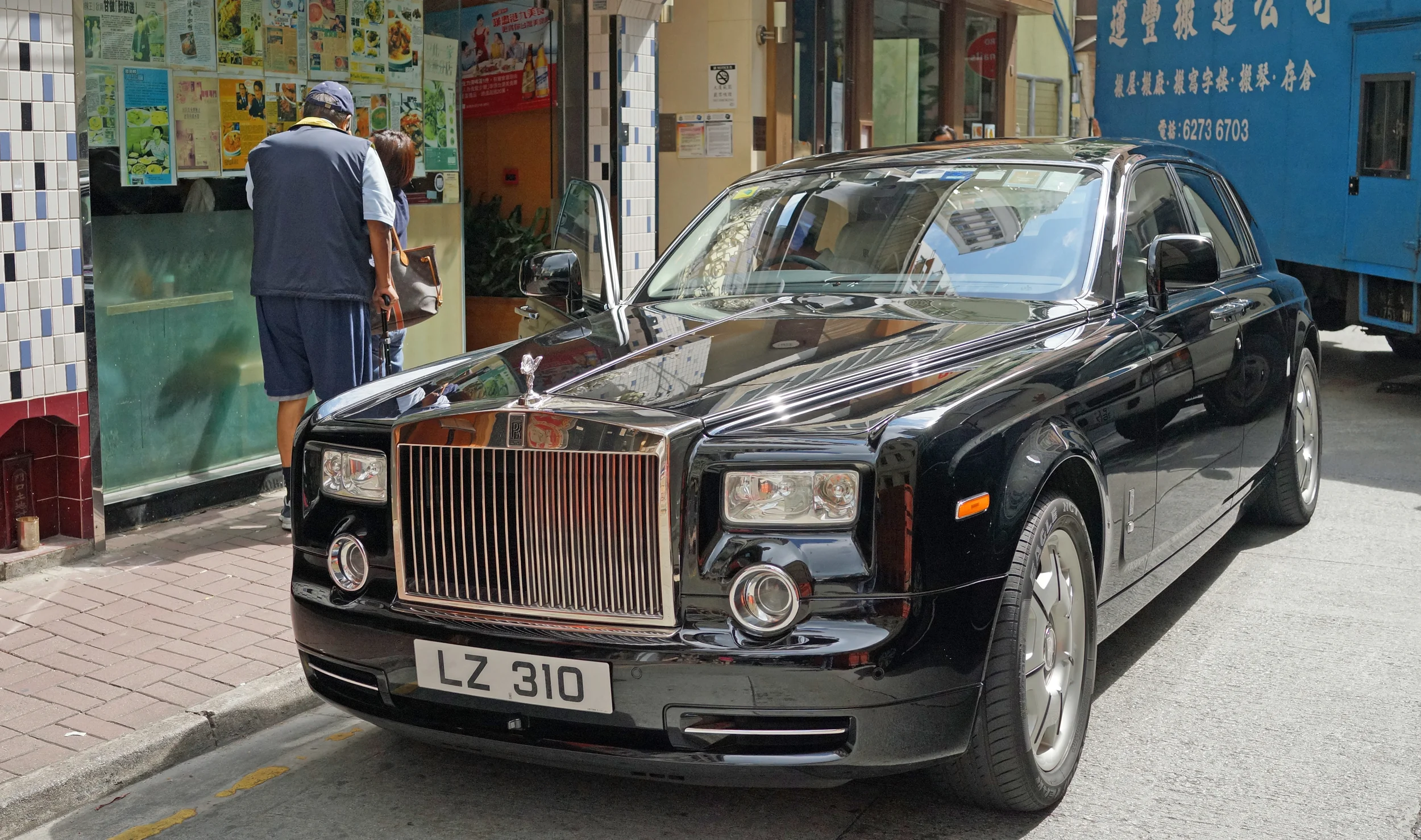 The old guy looking in the window of the dodgy restaurant is the owner of the Rolls Royce!