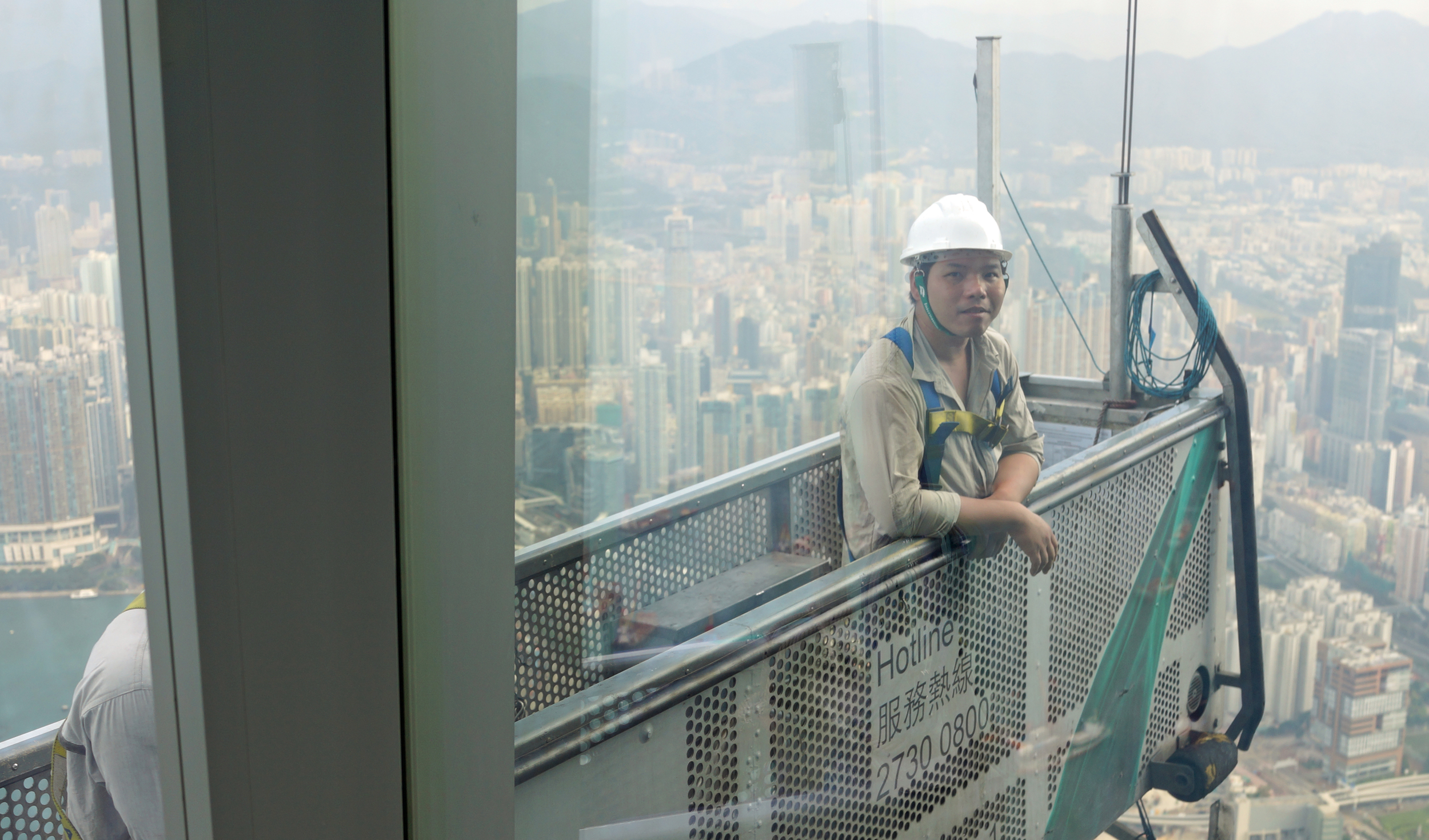 Well, at least it's not a clown, here I was minding my own business slurping some absurdly good coffee in the Ritz Carlton Lounge on the 116th floor when this rig bumped against the window... bloody nutters! cleaning windows at that height!!