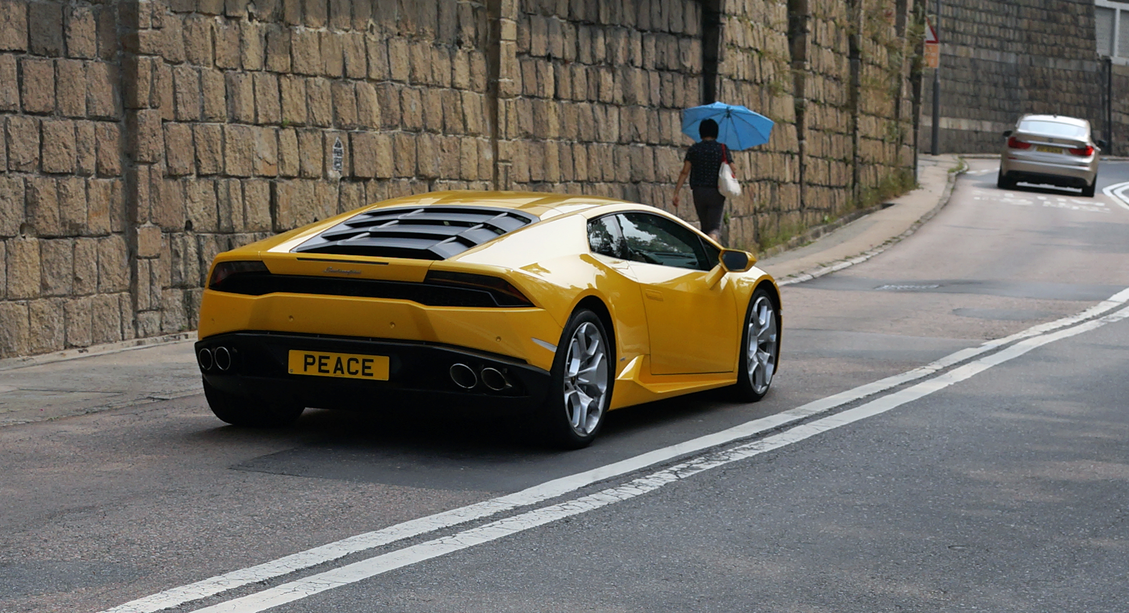 PEACE - an awesome Lamborghini with a great number plate blasting past the Hong Kong Country Club.