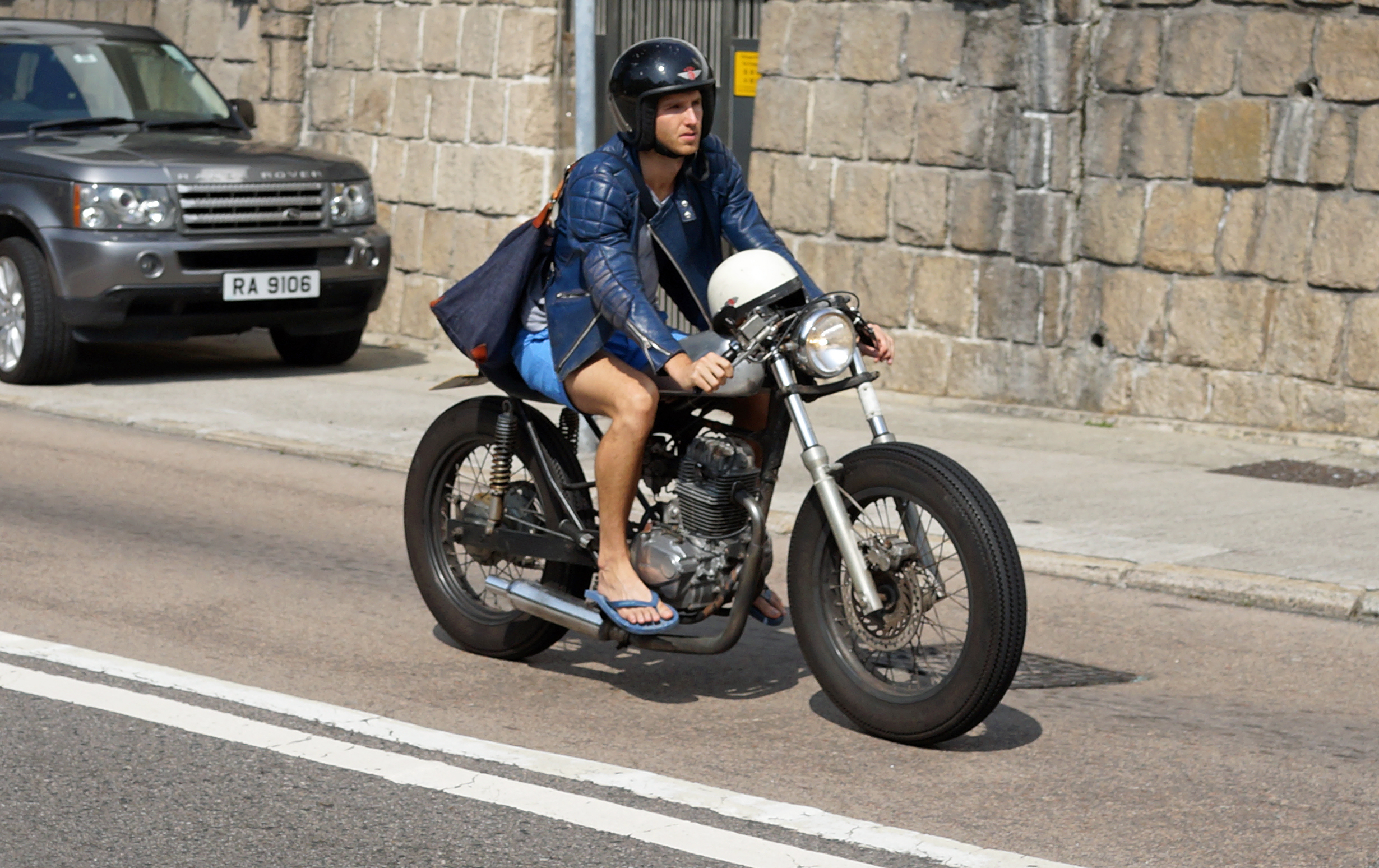 I have to say that this is a very odd motorbike and I am not sure riding a bike in flip flops is a good idea but hey, he looks cool.
