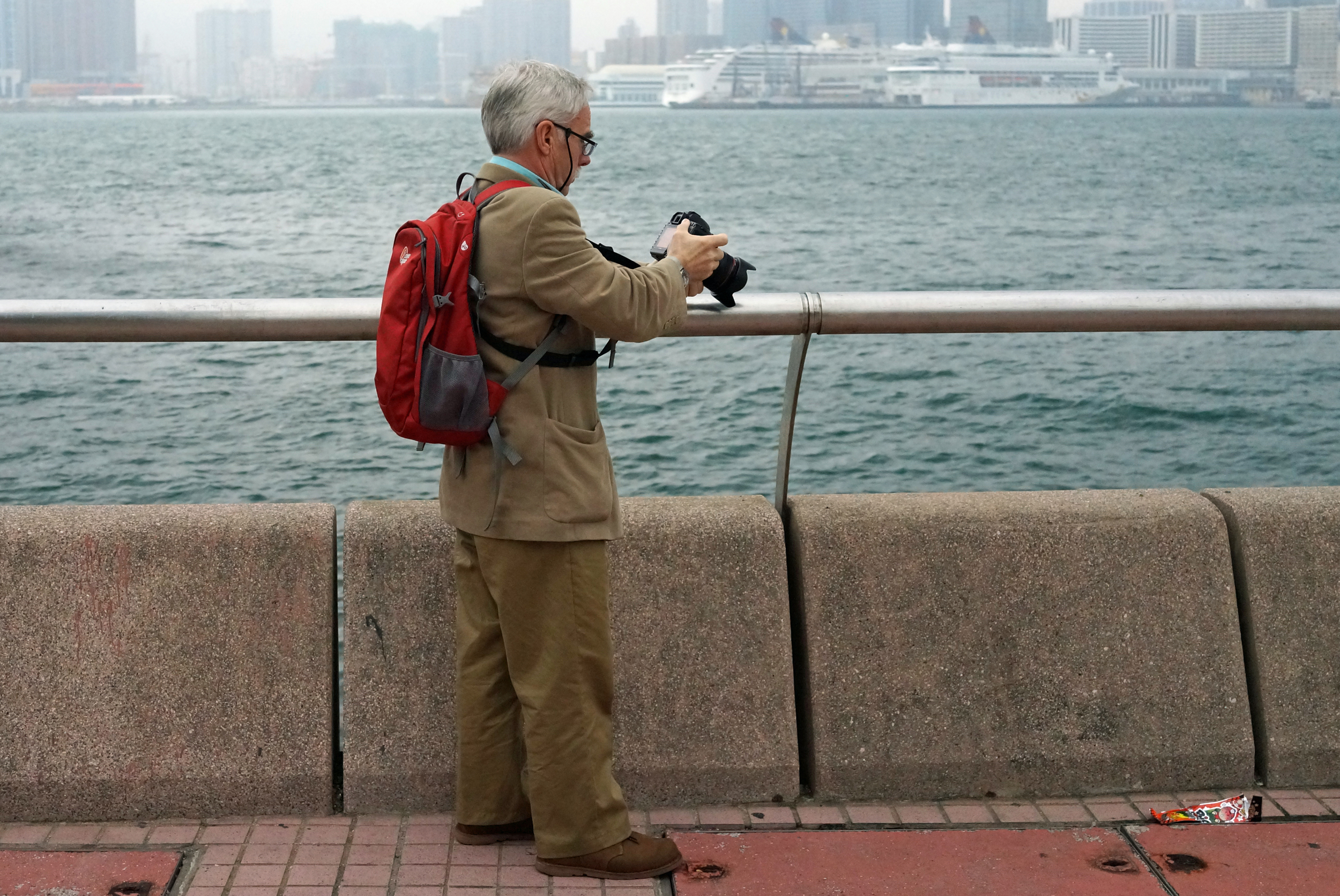 A tourist taking pictures next to the Star Ferry on Hong Kong Island