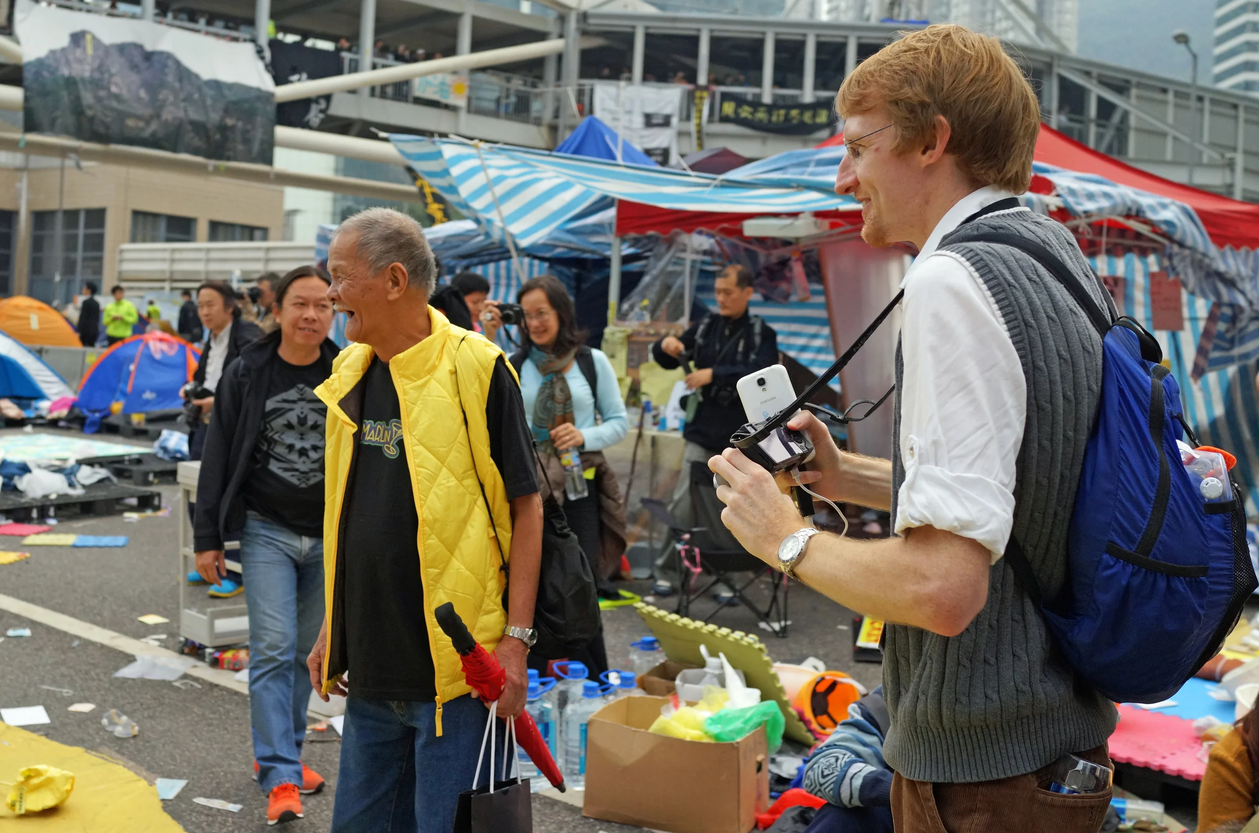 The chap taking the images is a local reporter on a budget given he was using a cheap camera and and a Samsung phone and was writing down notes by hand.