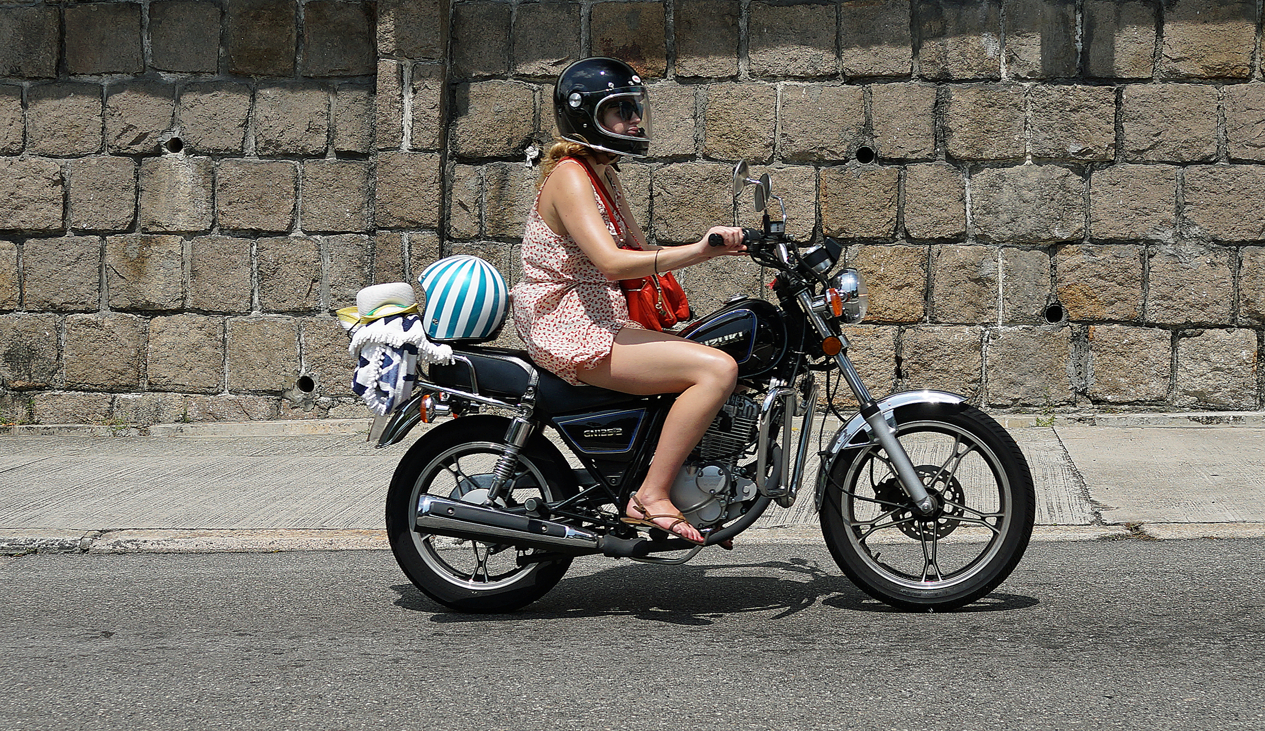 I am seeing more and more young ladies riding motorbikes (as opposed to the more traditional scooters) looks like this young lady is off to the beach!