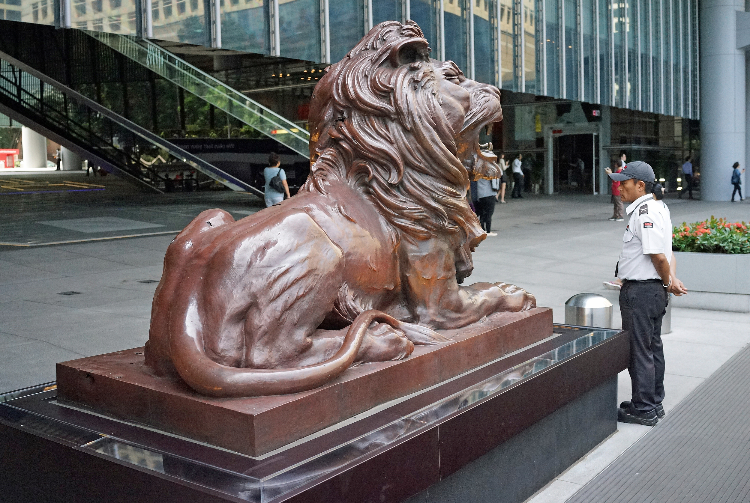 A Nepalese security guard keeps watch over one of the famous HSBC Lions ( I rub it's bottom every time I walk by, for luck you understand)