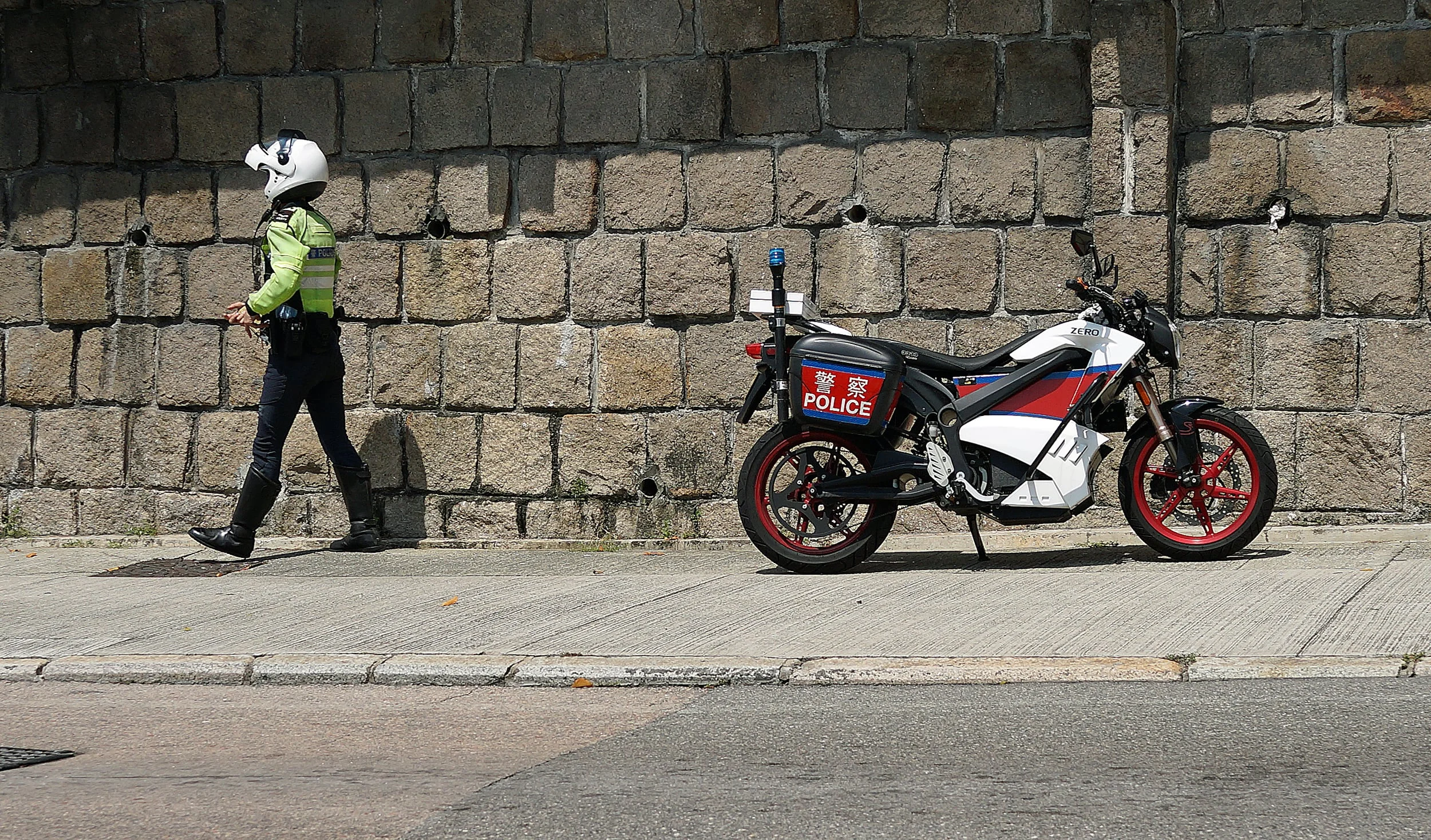 A traffic cop on his whizzo electric bike makes a stop opposite the Hong Kong Country Club to give out some tickets to patrons who illegally park...