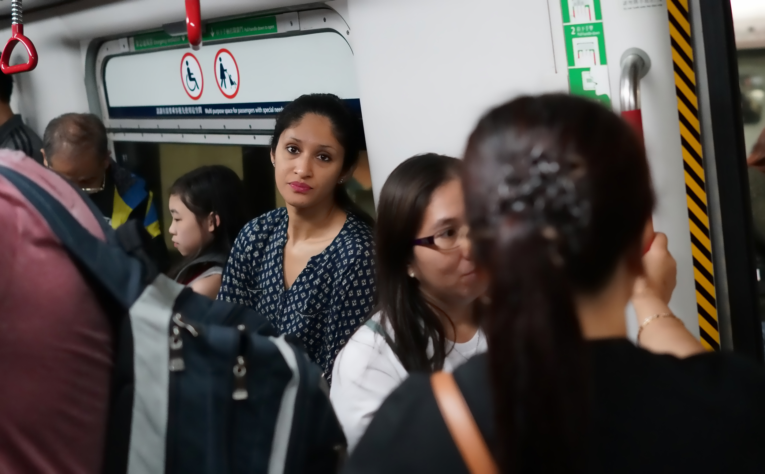 I have taken a lot of images over the past couple of years and this is my favourite, this young lady on our subway was looking away from the camera when I was focusing and bingo... it is like she is looking into my soul, I cannot decide if she is happy or sad.