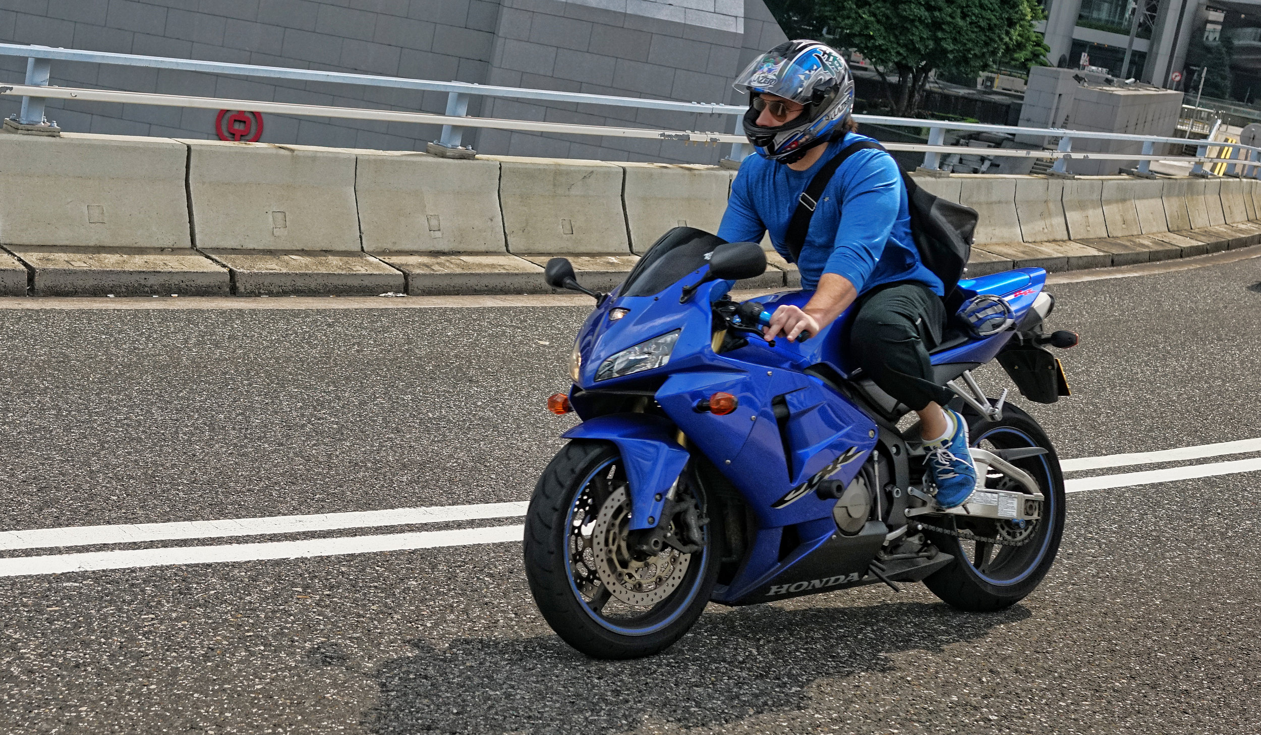 Blue guy, blue bike - very cool... on Garden Road in the Central Business District.