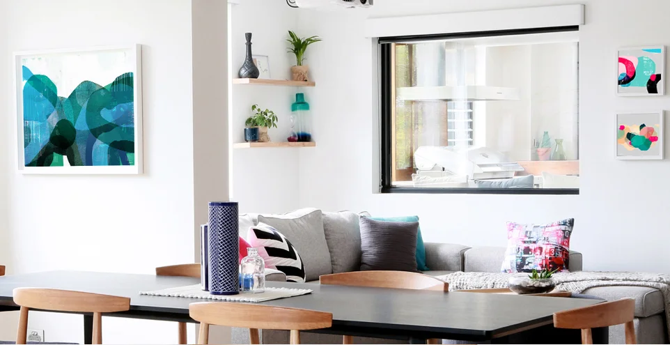 'Wetlands' (left) and customised prints of 'In the Pacific' and 'Peninsular' (far right) and tram cushion featured in Bec and Georges living area.