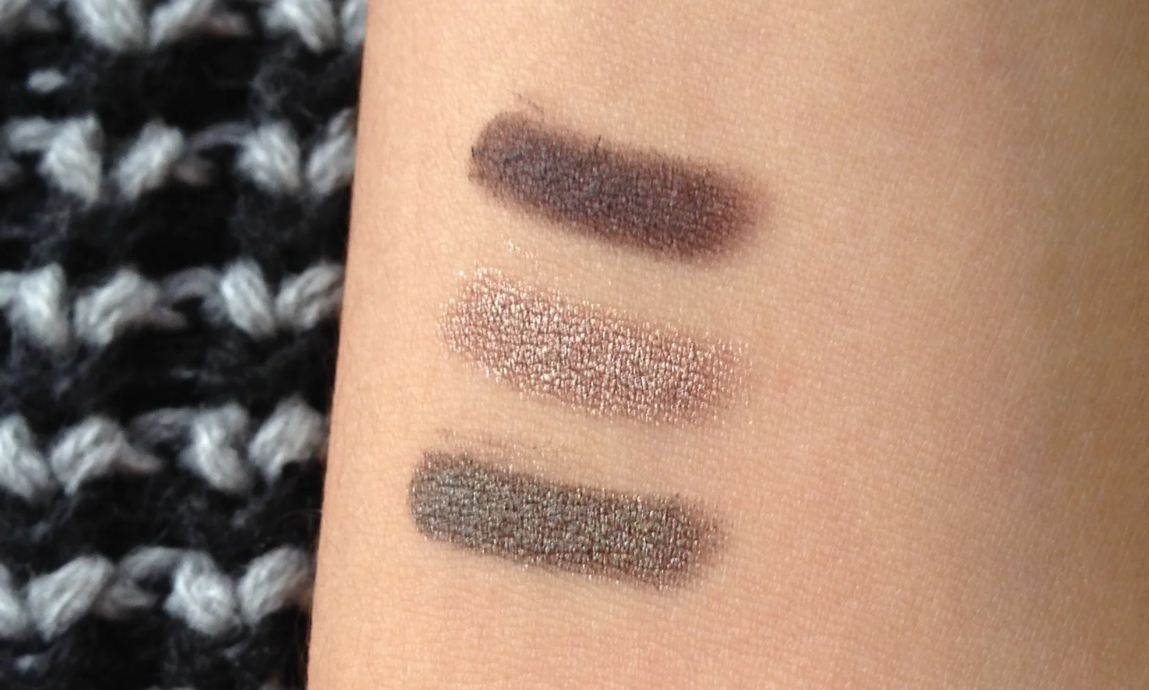 Swatches, Top to Bottom: Bobbi Brown Long Wear Cream Shadow Stick in Bark, By Terry Ombre Blackstar in Bronze Moon, Laura Mercier Caviar Stick in Khaki