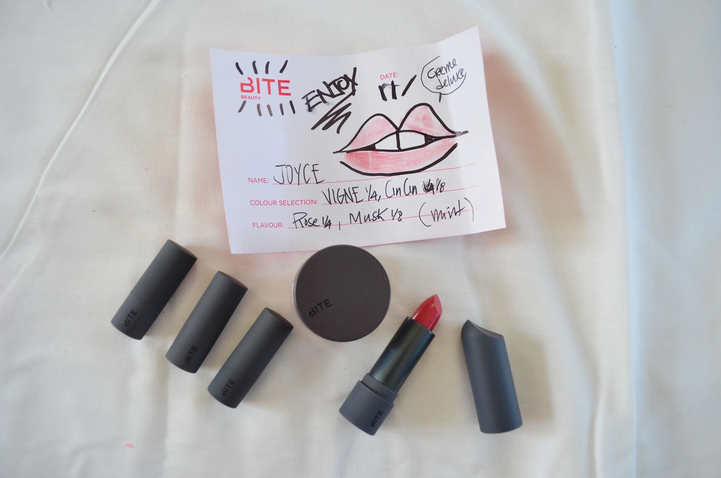 L-R: Bite Beauty Lipstick Samples, Bite Beauty Custom Lipstick & excess product in pot