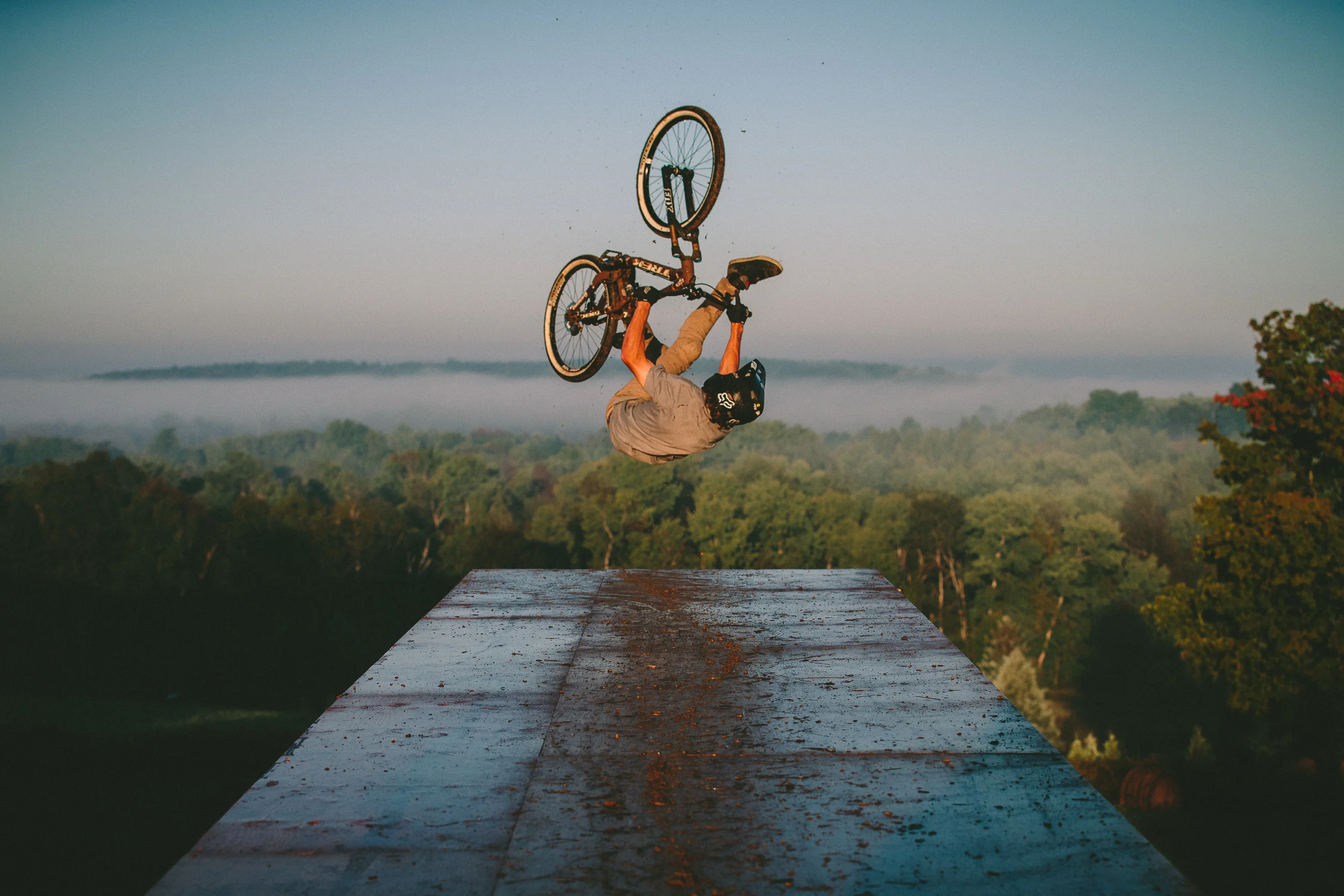 Brett Rheeder does a flip can drop off a muddy platform - Ontario Canada
