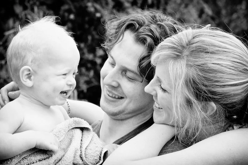 family portrait of mother, father and baby