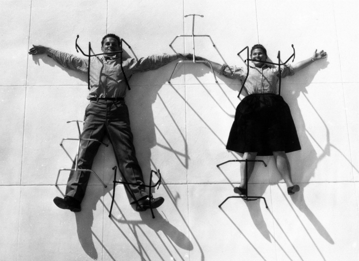 Charles and Ray Eames posing with chair bases© Eames Office LLC