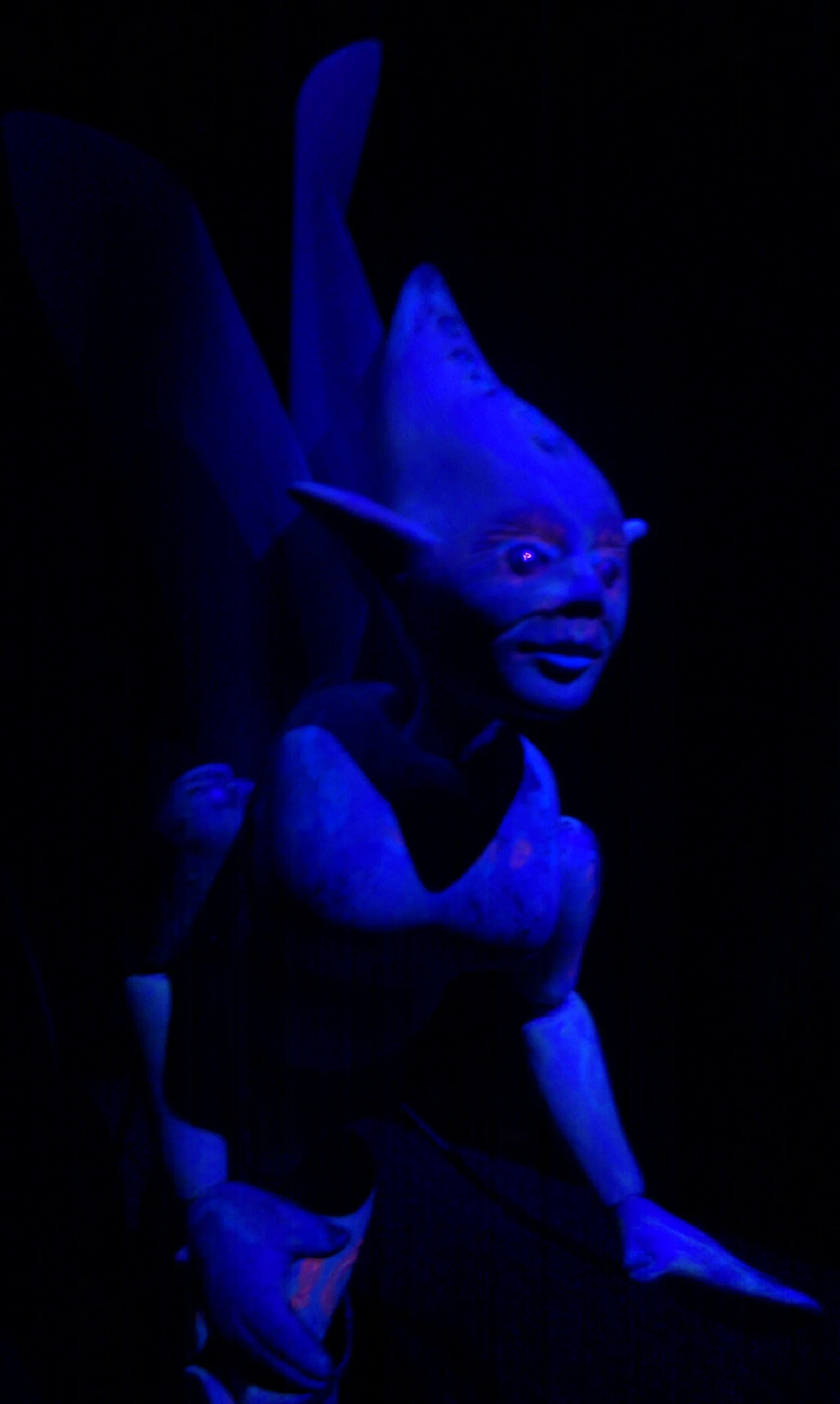 Black light micro puppetry inside the tent.