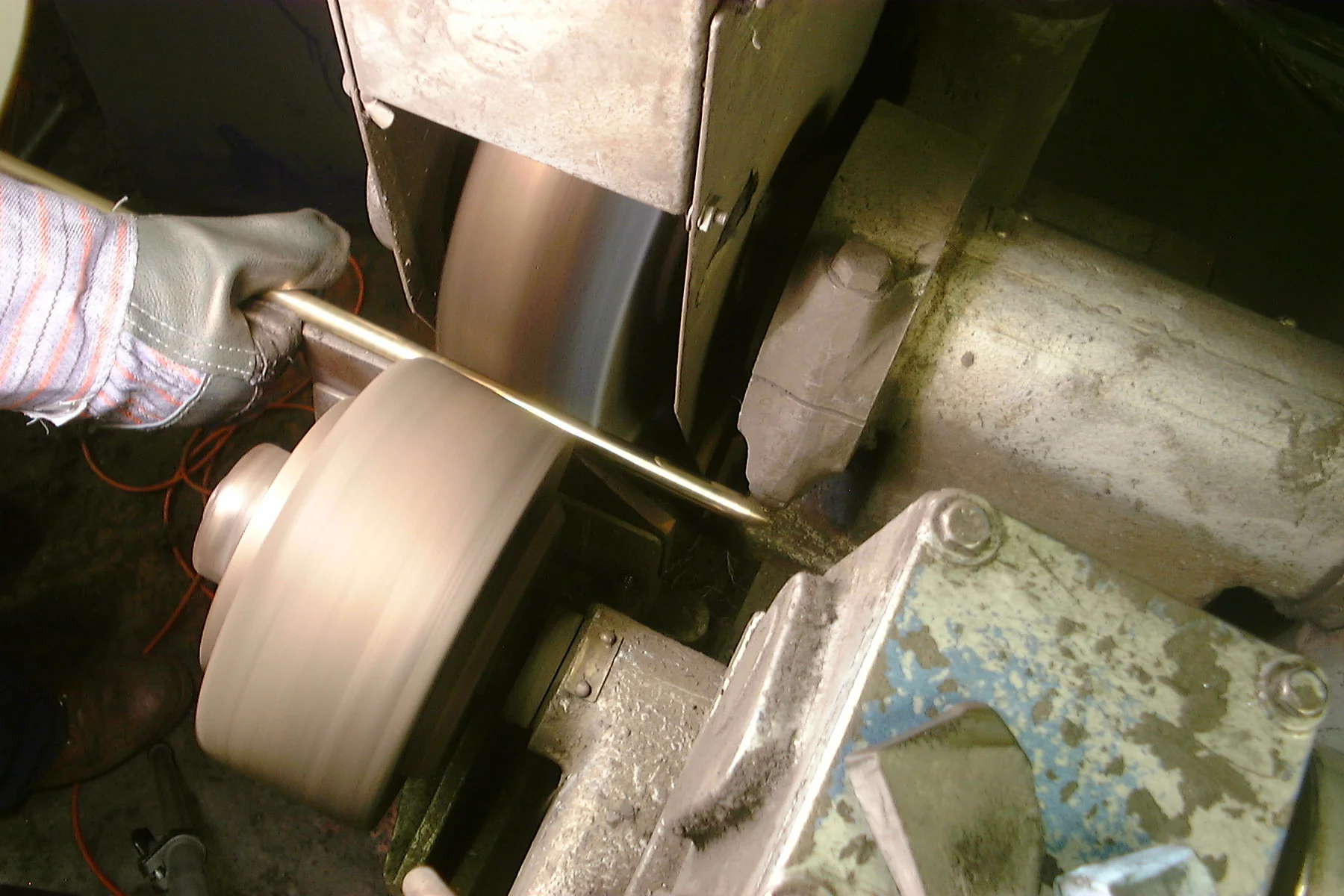 Brass stair rods being polished before applying lacquer.