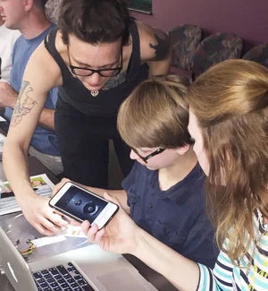 Jim McNally/Statesville Record & Landmark Hannah Mishin (left) helps put Houston Finley on the right track while his mother, Ginger Finley, looks on. Mishin was the facilitator at a Leadership Statesville workshop held at the Iredell County Library last week that explained simple computer programs.