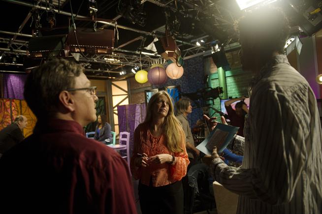 Producer Carol Pendergrass Caster, center, talks with Art Scene host Michael Gadlin between segments in Studio D in the City and County Building in Denver on Oct. 20, 2015. (THE DENVER POST | Seth McConnell)