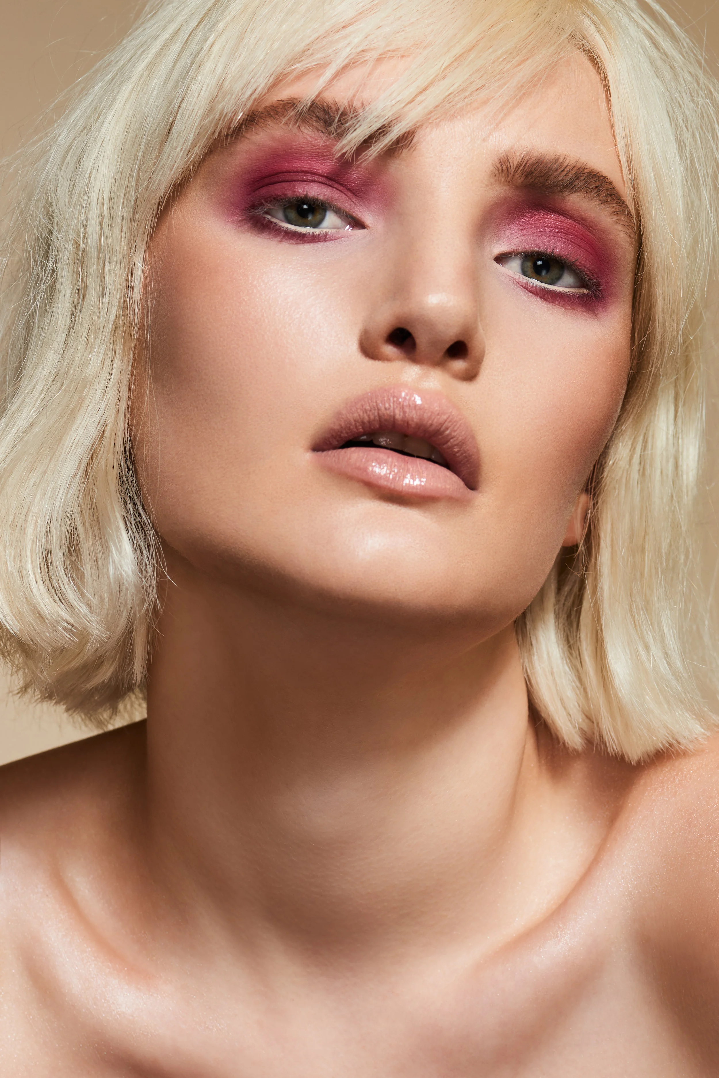 pale beauty model with blonde hair and pink coloured eyeshadow makeup 