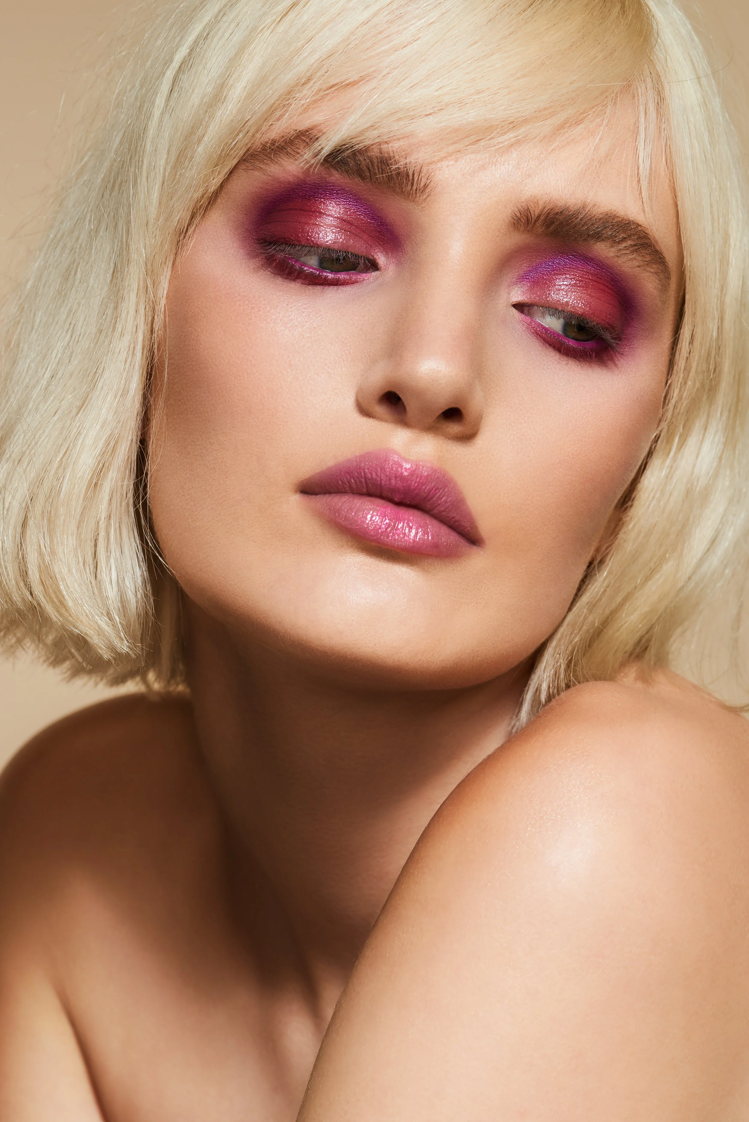beauty model with blonde hair and pink coloured eyeshadow makeup