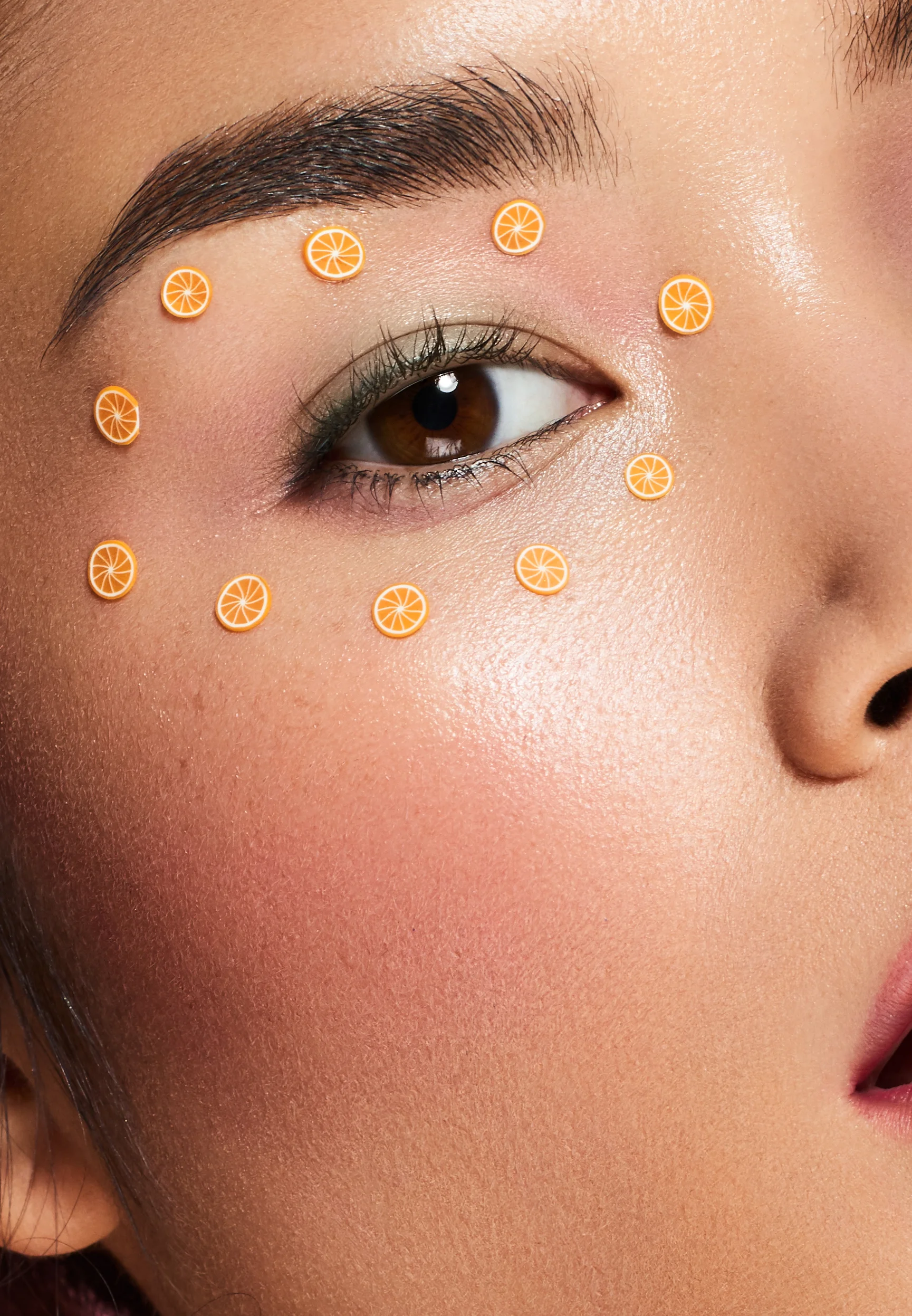 Close up macro shot of Asian beauty model with orange eye sticker makeup