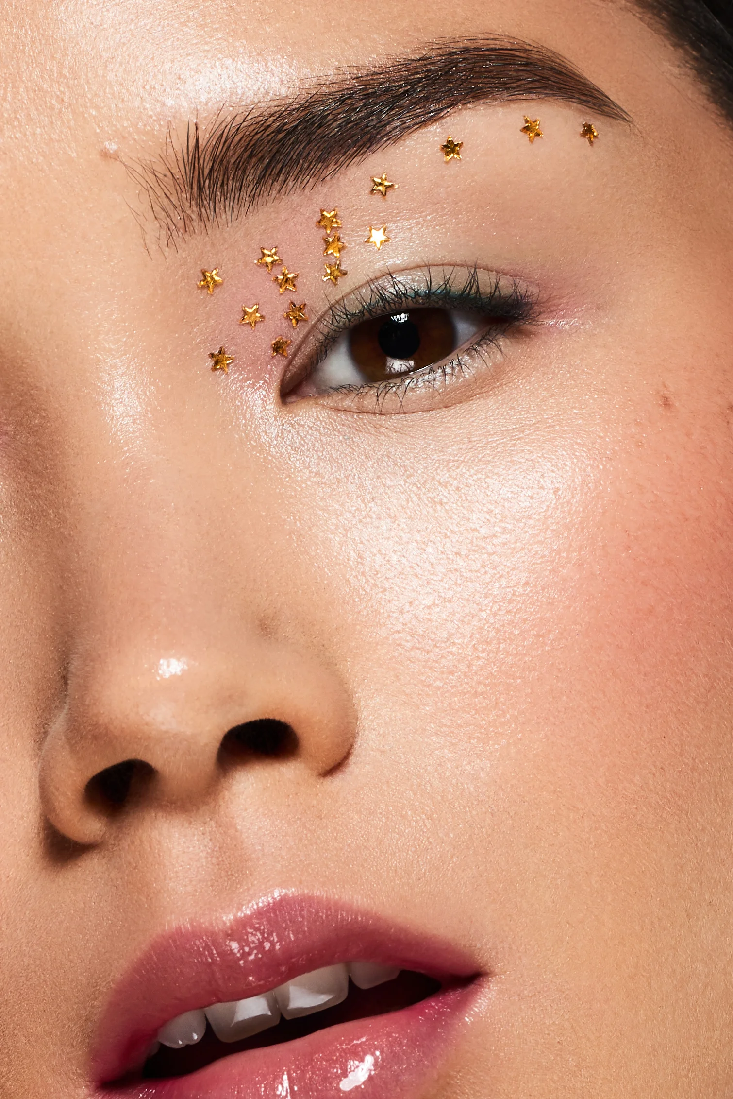 Close up macro shot of Asian beauty model with gold star eye makeup