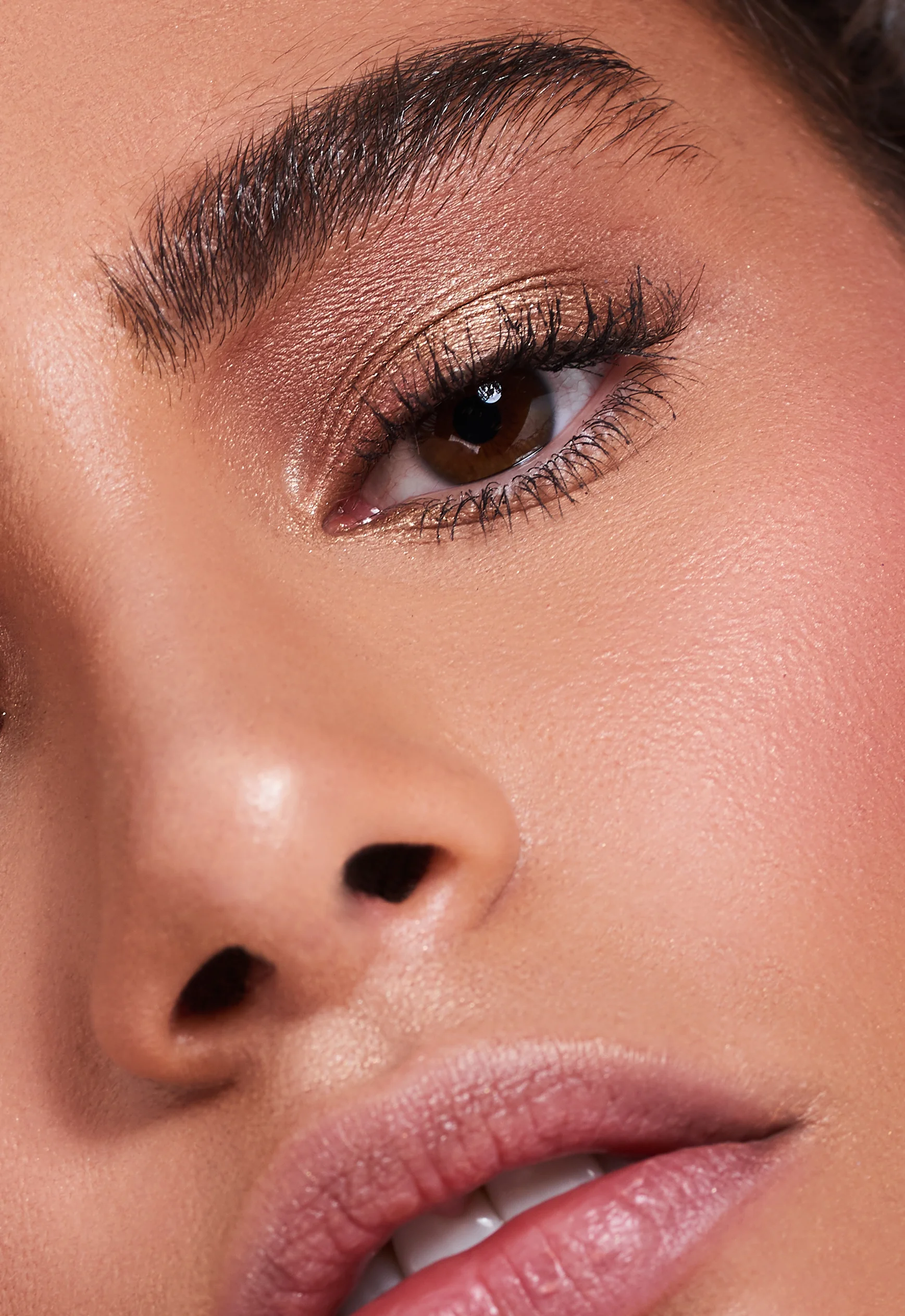 Macro close up of nude shimmer eyeshadow on female beauty model