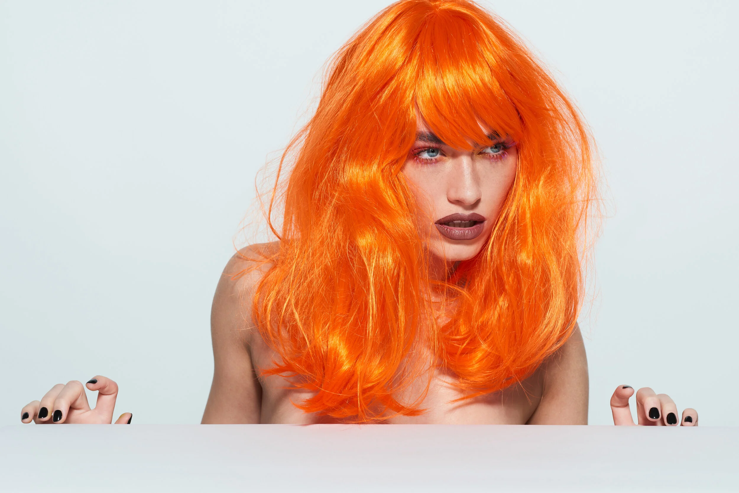 Female beauty model wearing a orange wig for LGBT Hair shoot