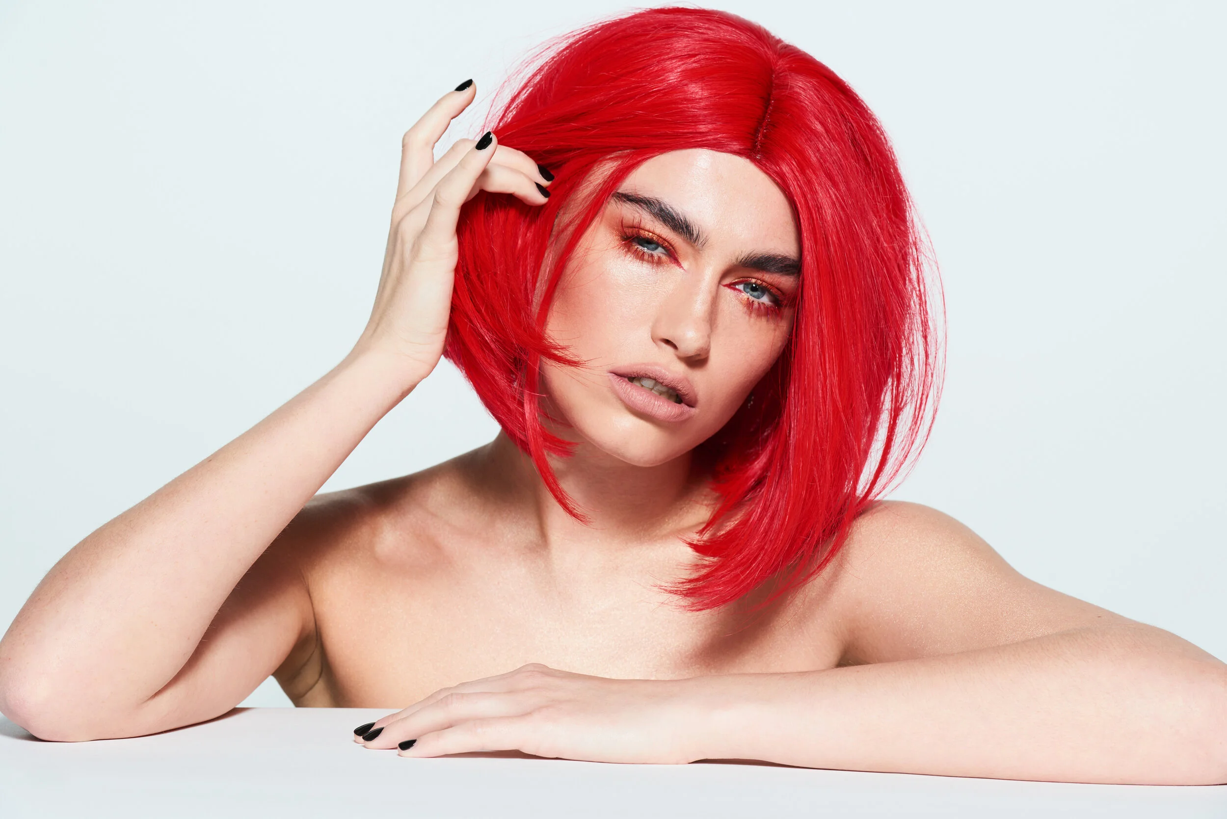 Female beauty model wearing a red wig for LGBT Hair shoot