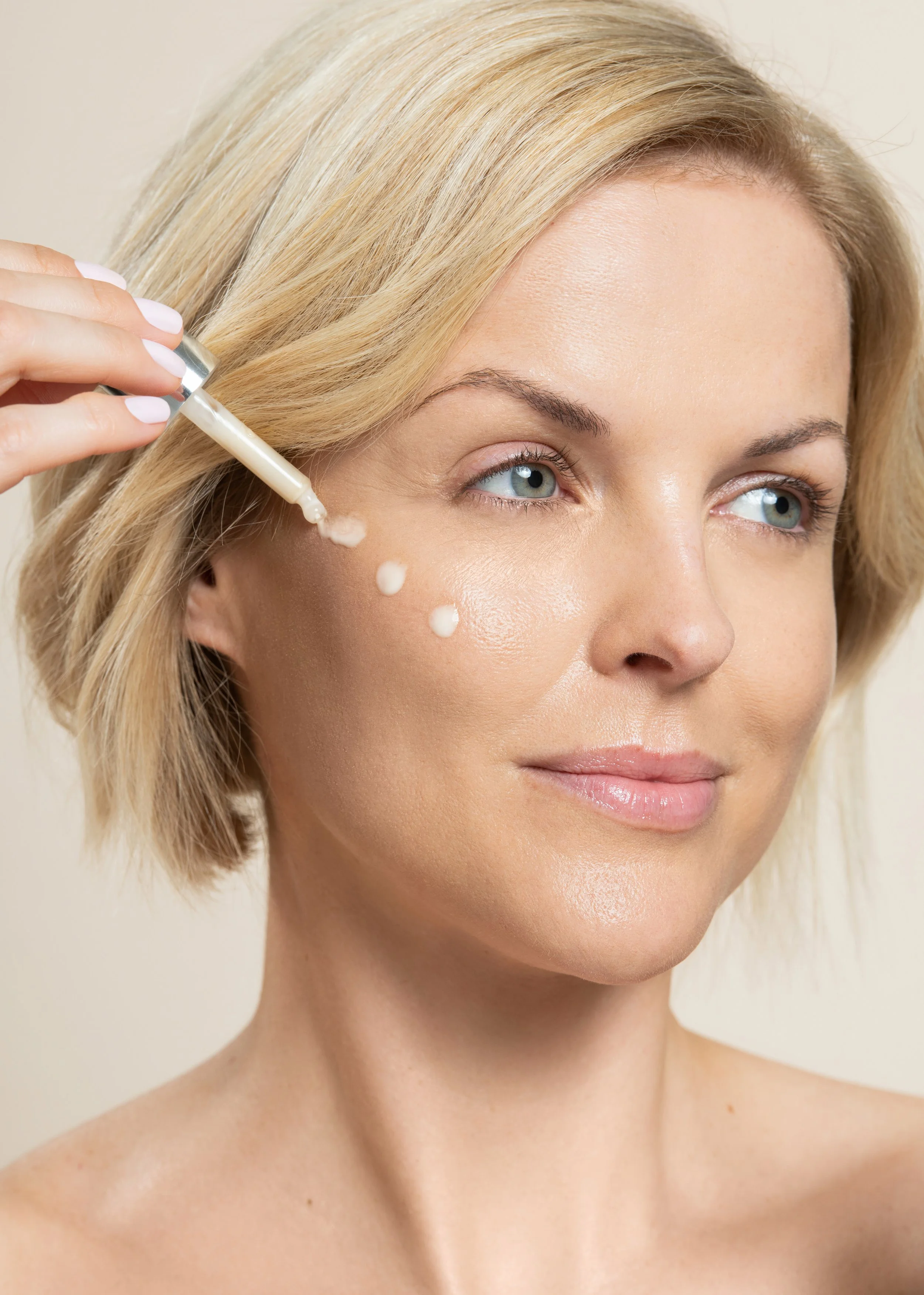 Beauty model applying skincare serum for Olivanna beauty photoshoot