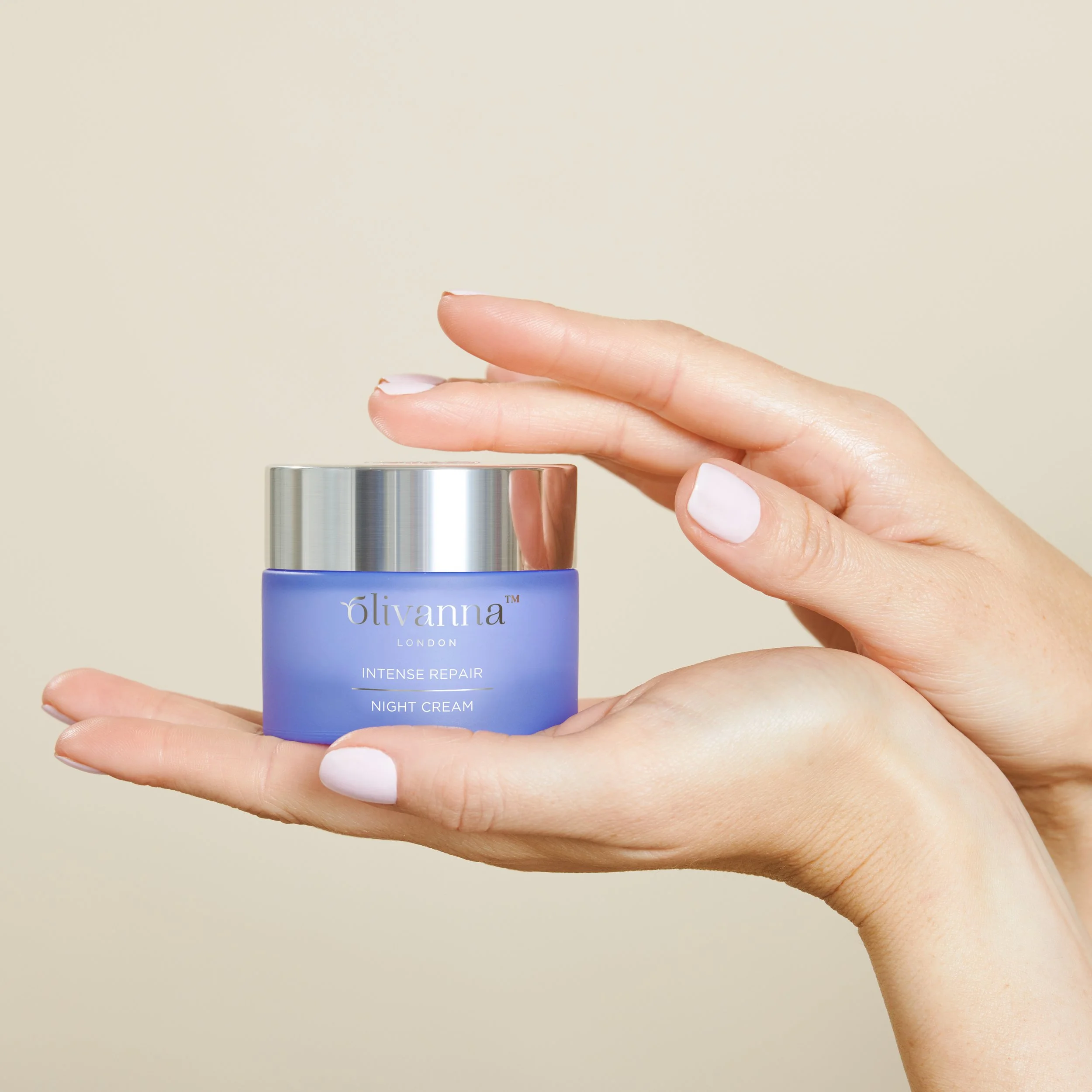 Womens hands holding a tub of Olivanna cream for skincare product photoshoot