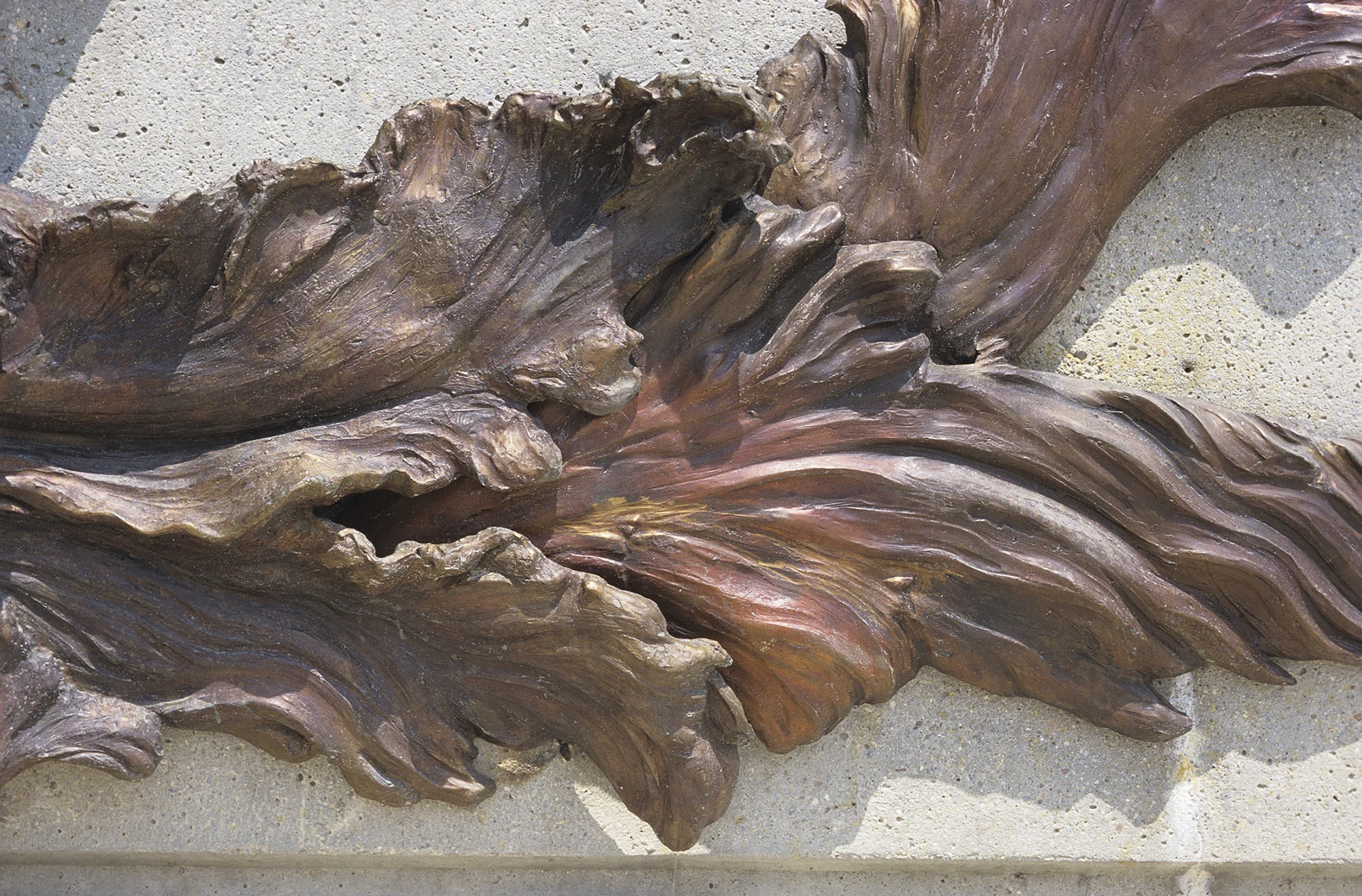 Floodwaters , bronze detail. The bronze has a complex hot patina using ferric oxide, liver of sulphur, and other acids, finished with a hot wax and buffed. This gives it its variegated, shifting colors.
