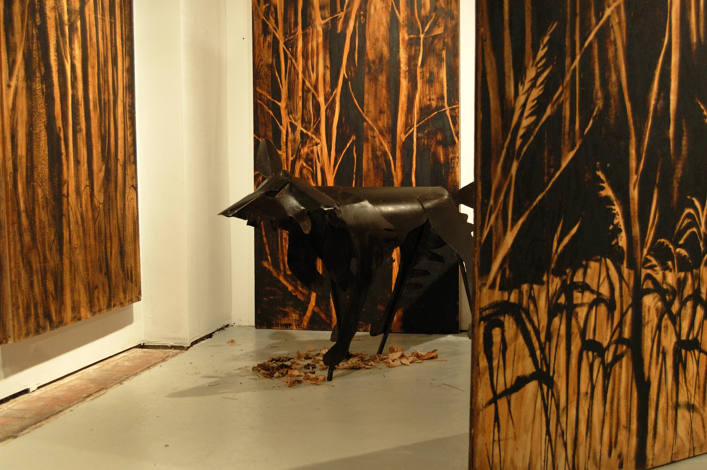 "Living Room" was a one-person show at Gallery 13, 811 LaSalle St., Minneapolis, MN.
The animals are life-size, Corten steel, the panels, both freestanding
and wall-hung, are each 4' x 8' plywood, painted in asphaltum. The wolf here is called "Grimm's Wolf" and depicts human view of wolf as predator: the Big Bad one.