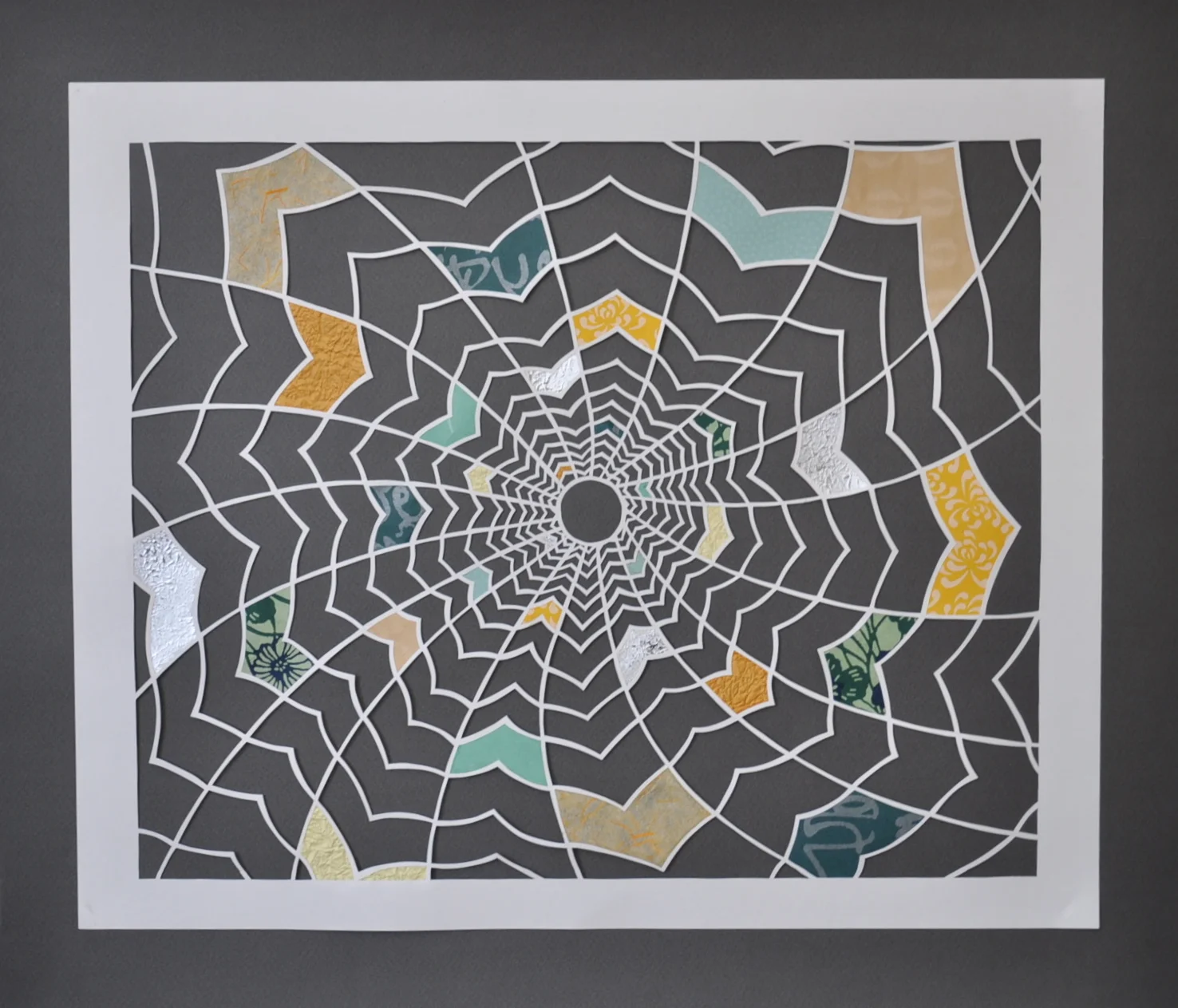 "Geomancy" Measures 17 x 19 1/2 inches. White paper cut with inserts of multi-coloured textured Japanese art papers against a dark grey background. Available for purchase on Etsy .