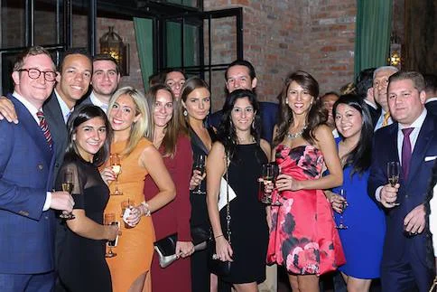 Lena, center in a red strapless dress, celebrated her birthday with friends and raised $4,000 for Project Renewal.