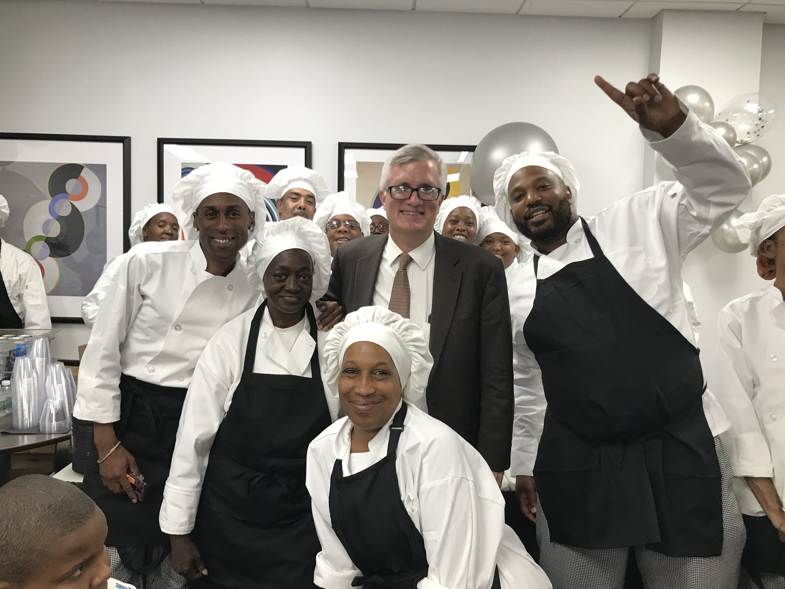 New York State Senator Brian Kavanagh celebrates with our Culinary Arts Training Program graduates