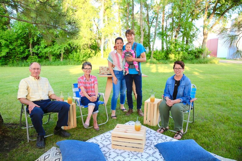 Nick, Molly & their baby pose with Nick's parents and Molly's Mom before outdoor movie night.jpeg