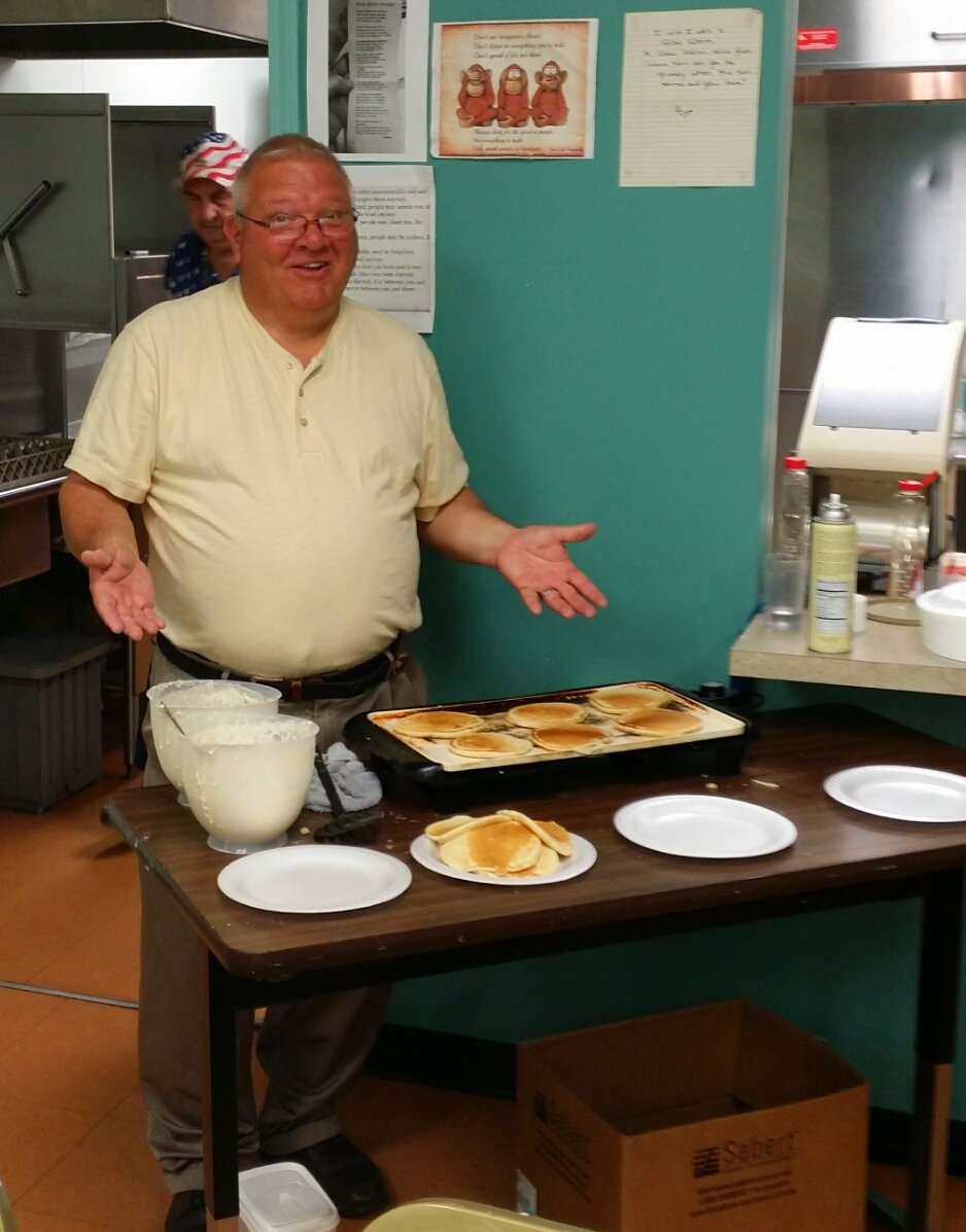  Greg serving pancakes during the breakfast hour. 