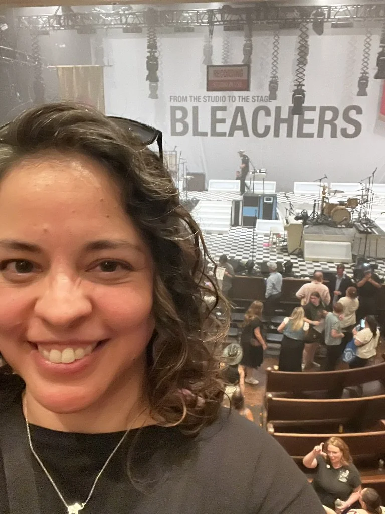 me, smiling while attending a Bleachers concert