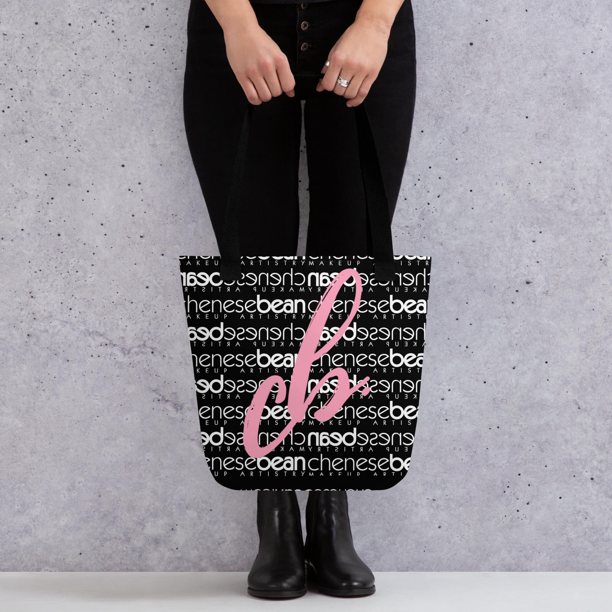 CBMA black tote bag - model holding tote.png