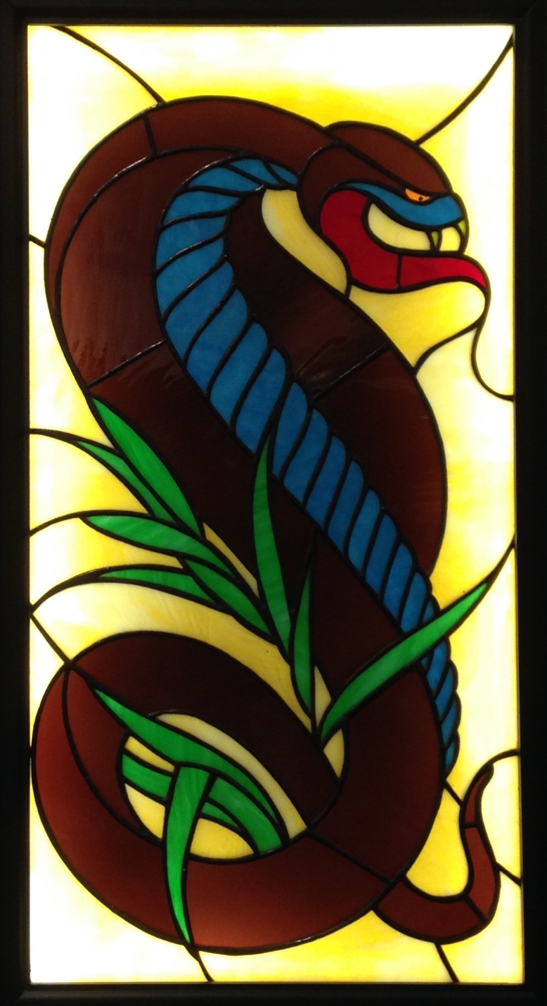 "REX ASPIDIS" 16"X31" (SIZE OF GLASS ONLY) Foiled stained glass, kiln fired glass paint, & LED lights $2250