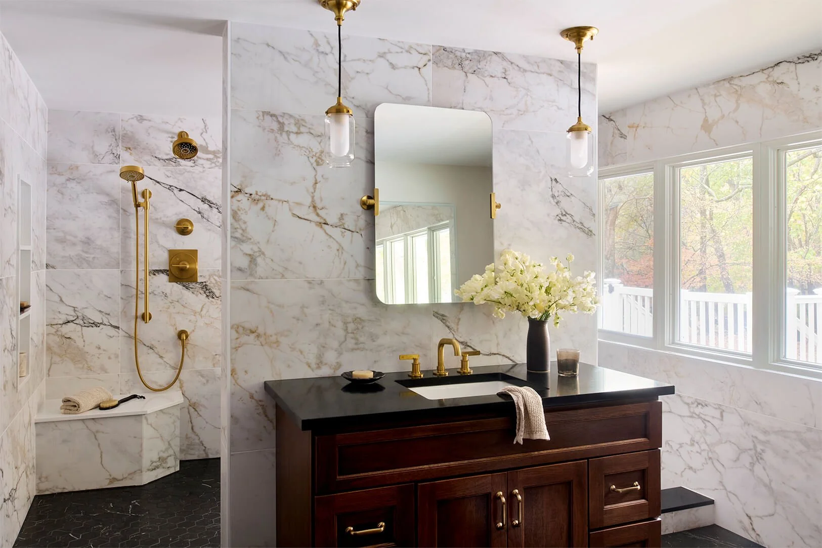 Vanity area with a wet room in the background. Floor to ceiling marble look tile.