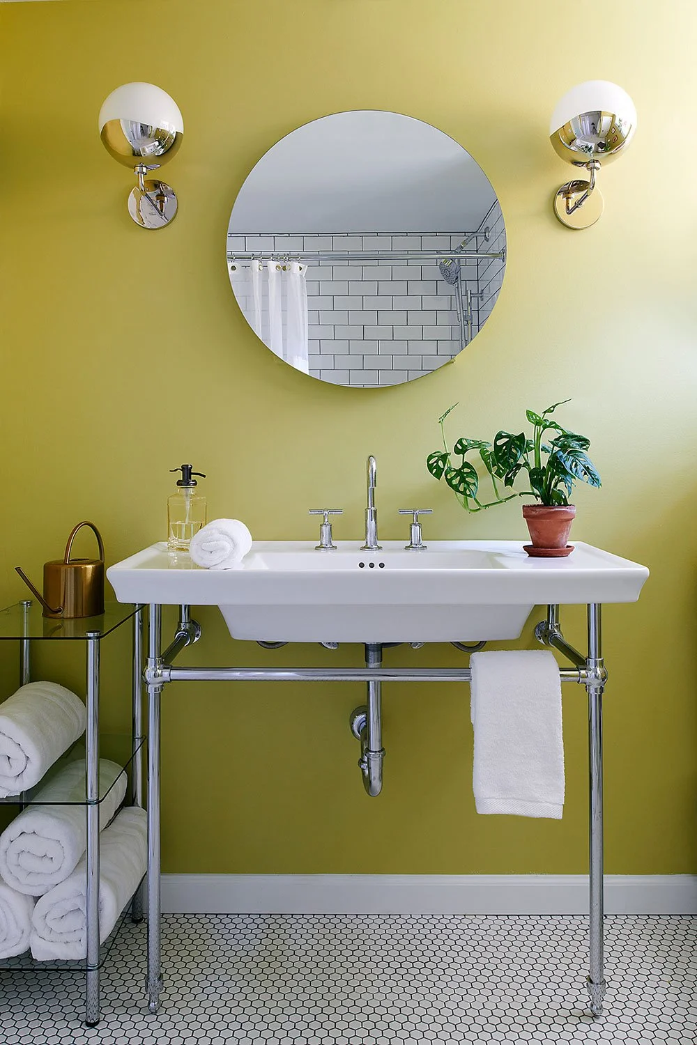 Classic console vanity in front of a lime green wall.