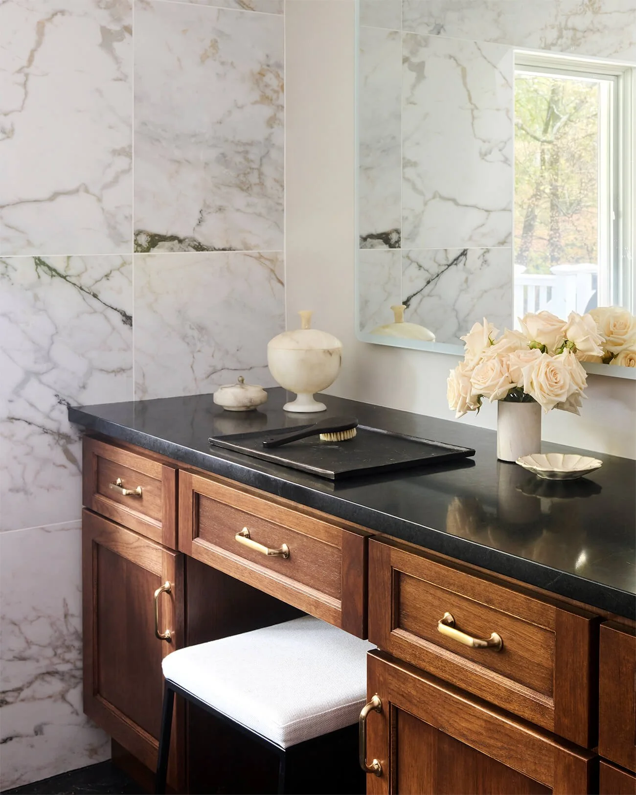 Walnut makeup vanity with soapstone countertop.